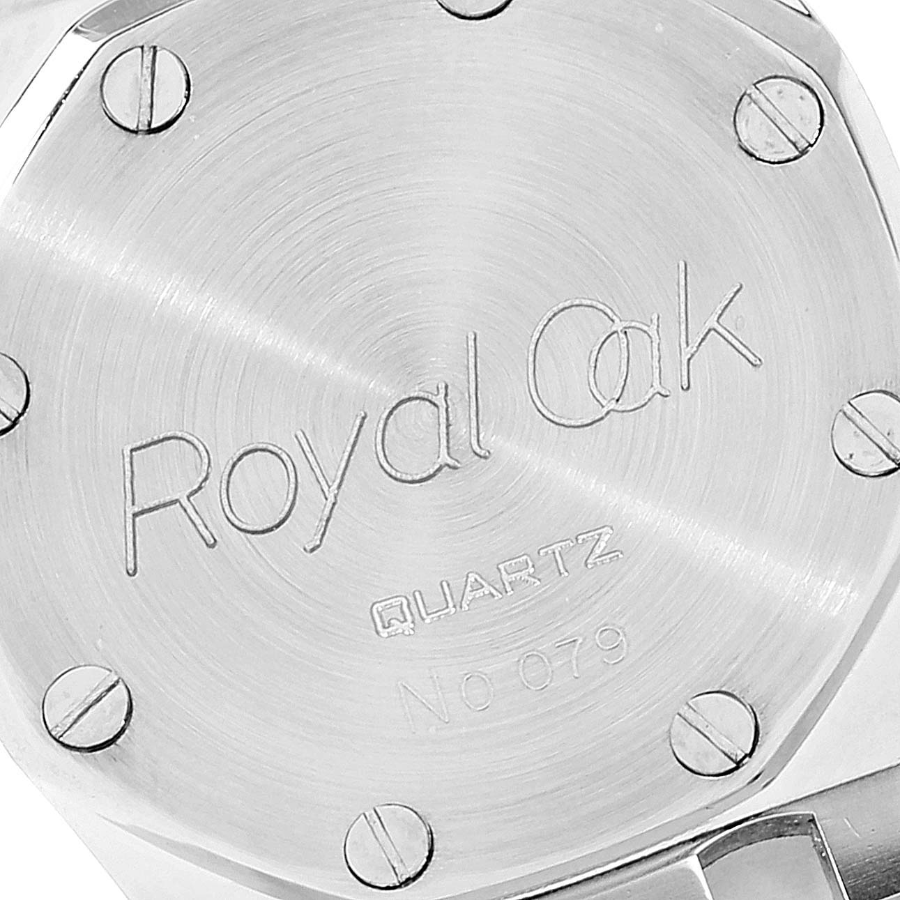 The image shows the back case of an Audemars Piguet Royal Oak 6131-516 Women's Steel and Gold (two tone) Grey Dial 6131-516 Women's Steel and Gold (two tone) Grey Dial Quartz watch, featuring engraved text and screws.