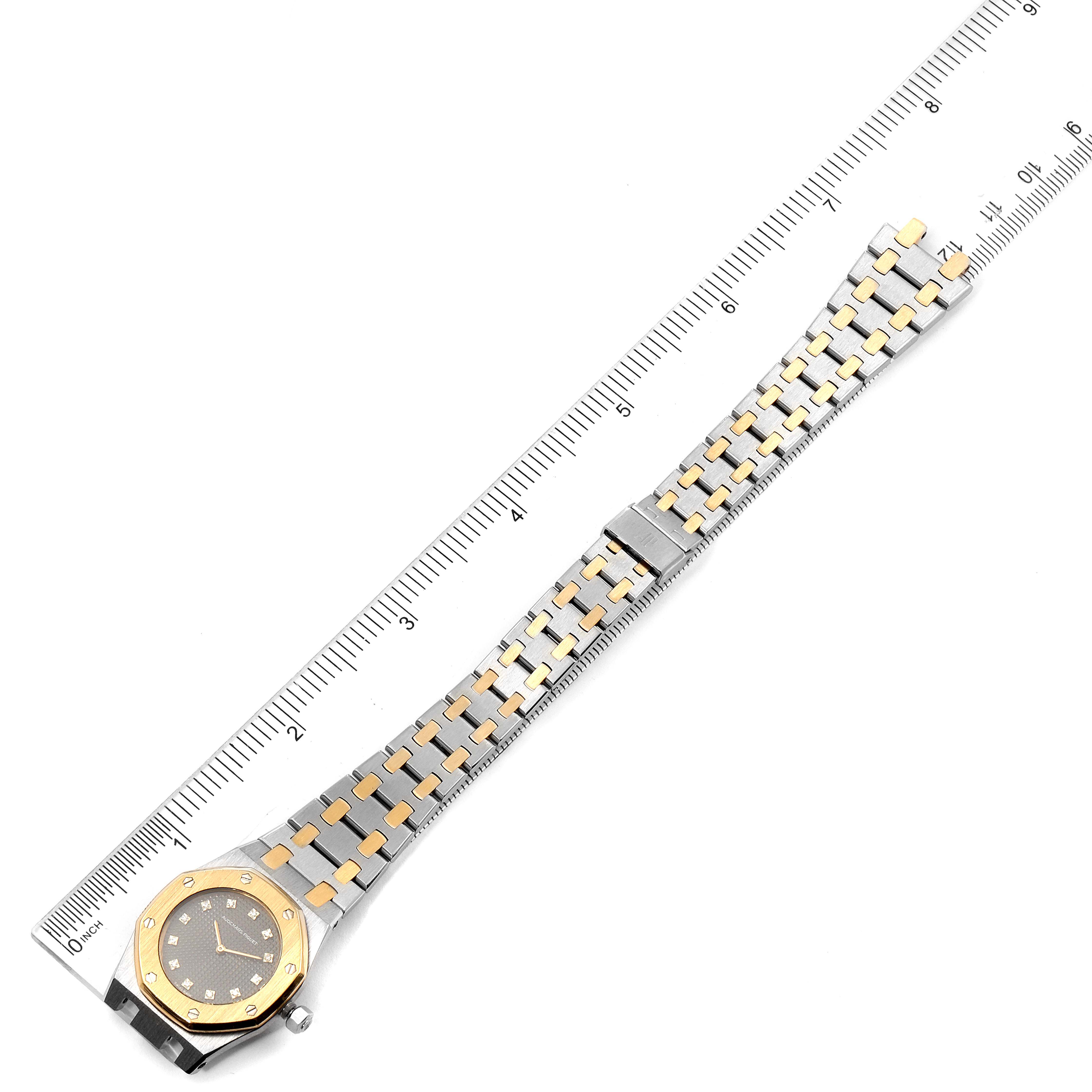 This image shows the top view of an Audemars Piguet Royal Oak 6131-516 Women's Steel and Gold (two tone) Grey Dial 6131-516 Women's Steel and Gold (two tone) Grey Dial watch, highlighting its two-tone bracelet and ruler for scale.