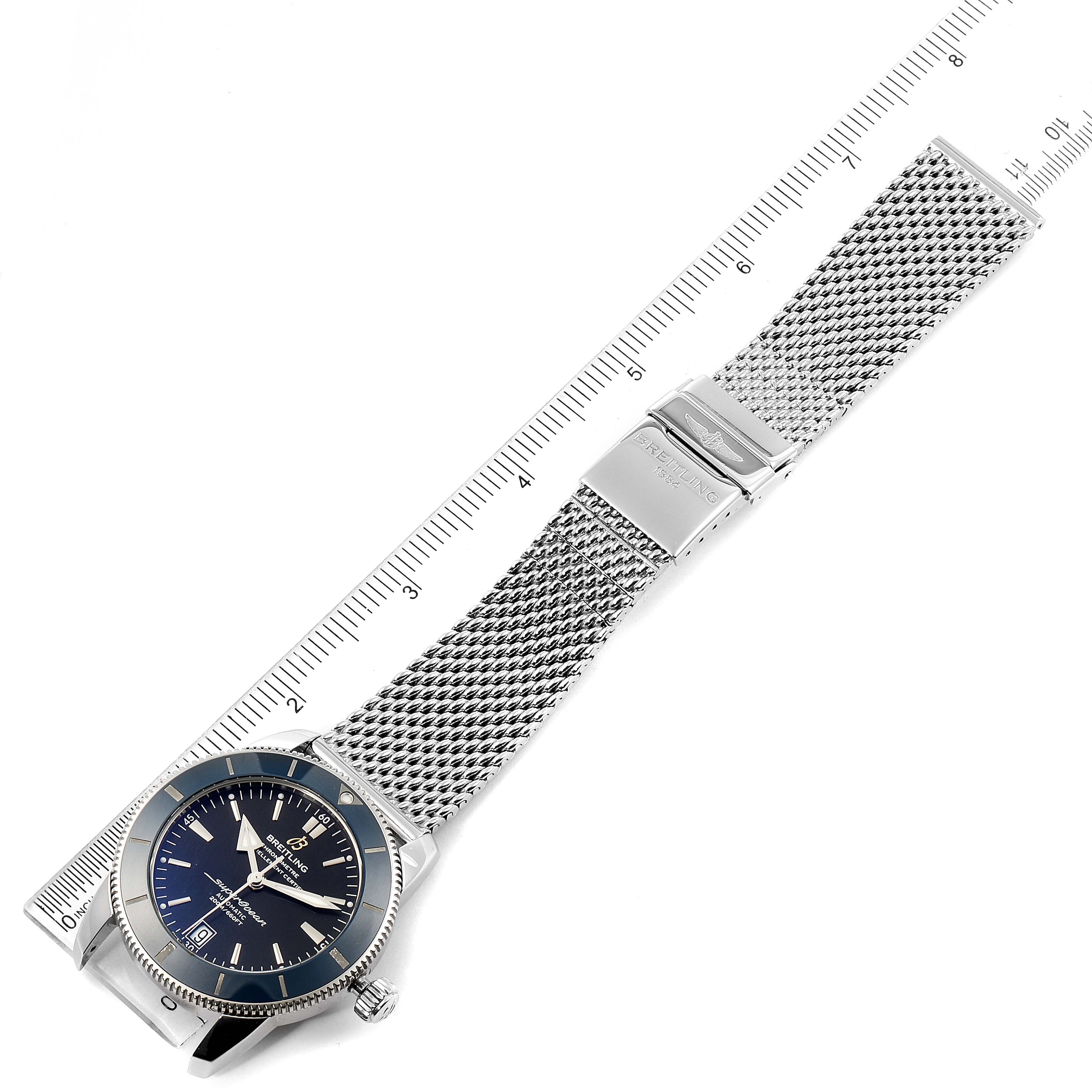 The image shows an overhead view of a Breitling Superocean AB2010161C1A1 Men's Stainless Steel Black Dial AB2010161C1A1 Men's Stainless Steel Black Dial watch, displaying its face, bezel, and mesh bracelet with a clasp.