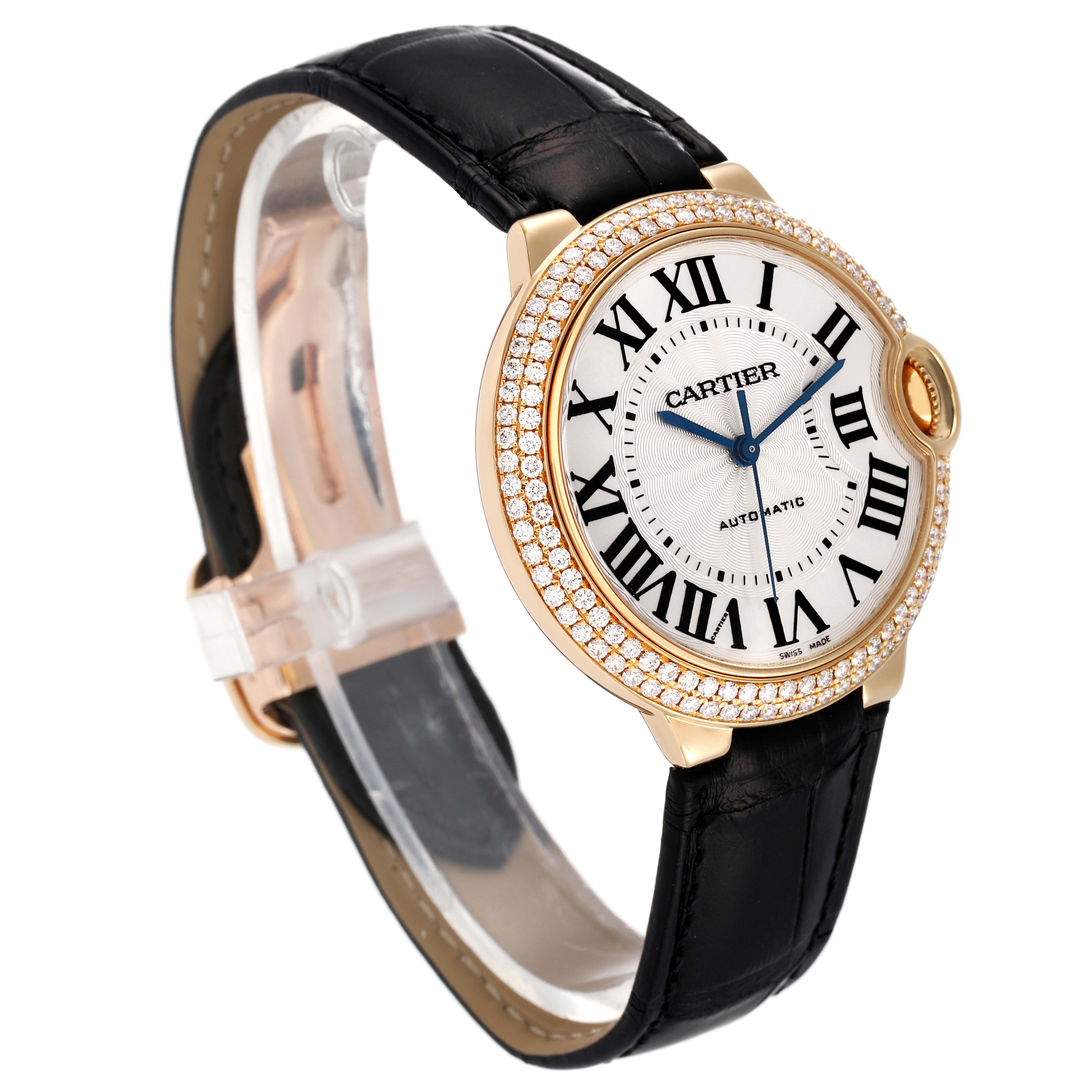 The Cartier Ballon Bleu WE900451 Men's Yellow Gold Silver Dial WE900451 Men's Yellow Gold Silver Dial watch is shown at a three-quarter angle, highlighting its diamond-studded bezel, dial, and strap.