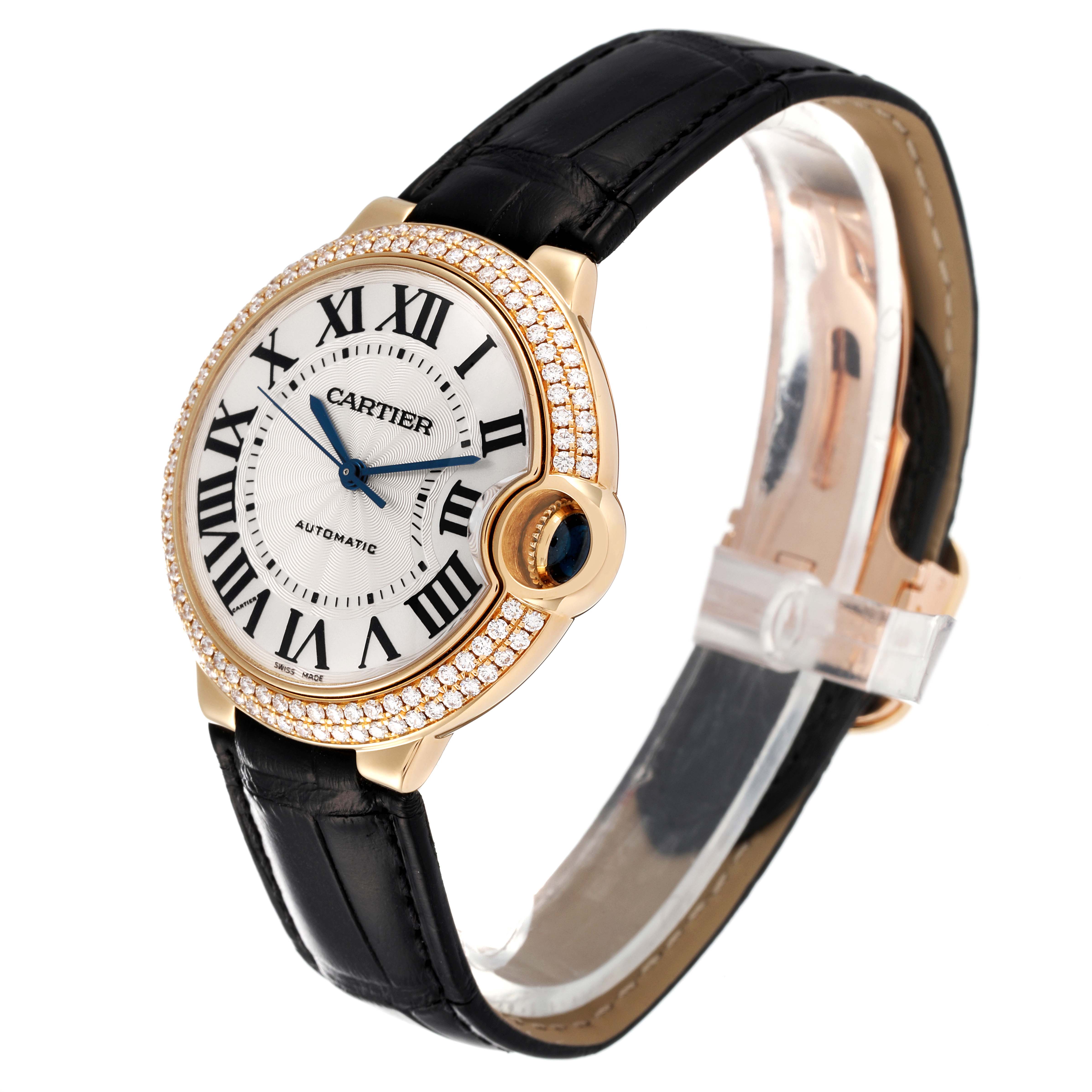 The image shows a Cartier Ballon Bleu WE900451 Men's Yellow Gold Silver Dial WE900451 Men's Yellow Gold Silver Dial watch at a slight angle, highlighting its face, black strap, and diamond-studded bezel.