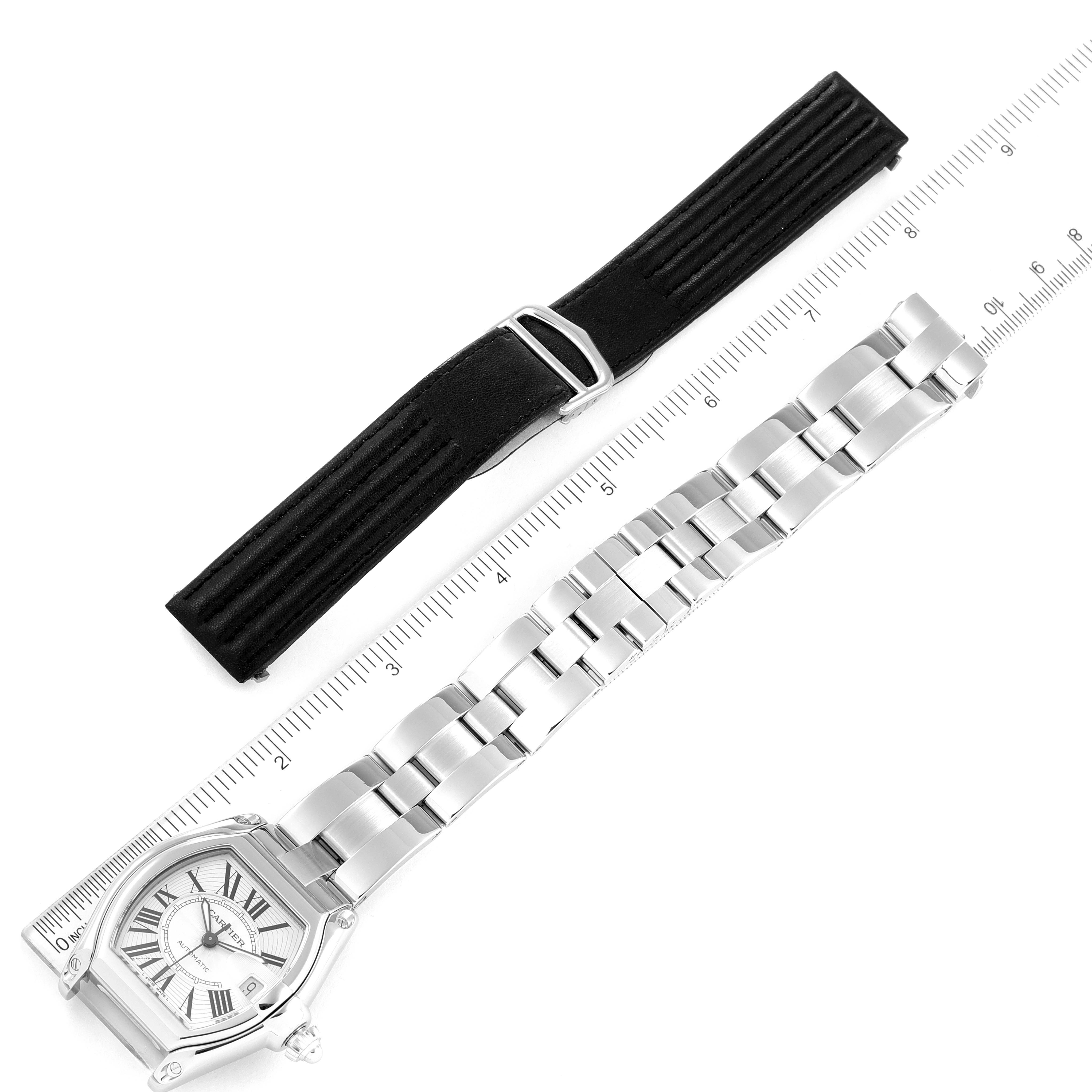 The image shows the Cartier Roadster W62025V3 Men
s Stainless Steel Silver Dial W62025V3 Men
s Stainless Steel Silver Dial watch in a flat lay with its stainless steel bracelet and an additional black strap.