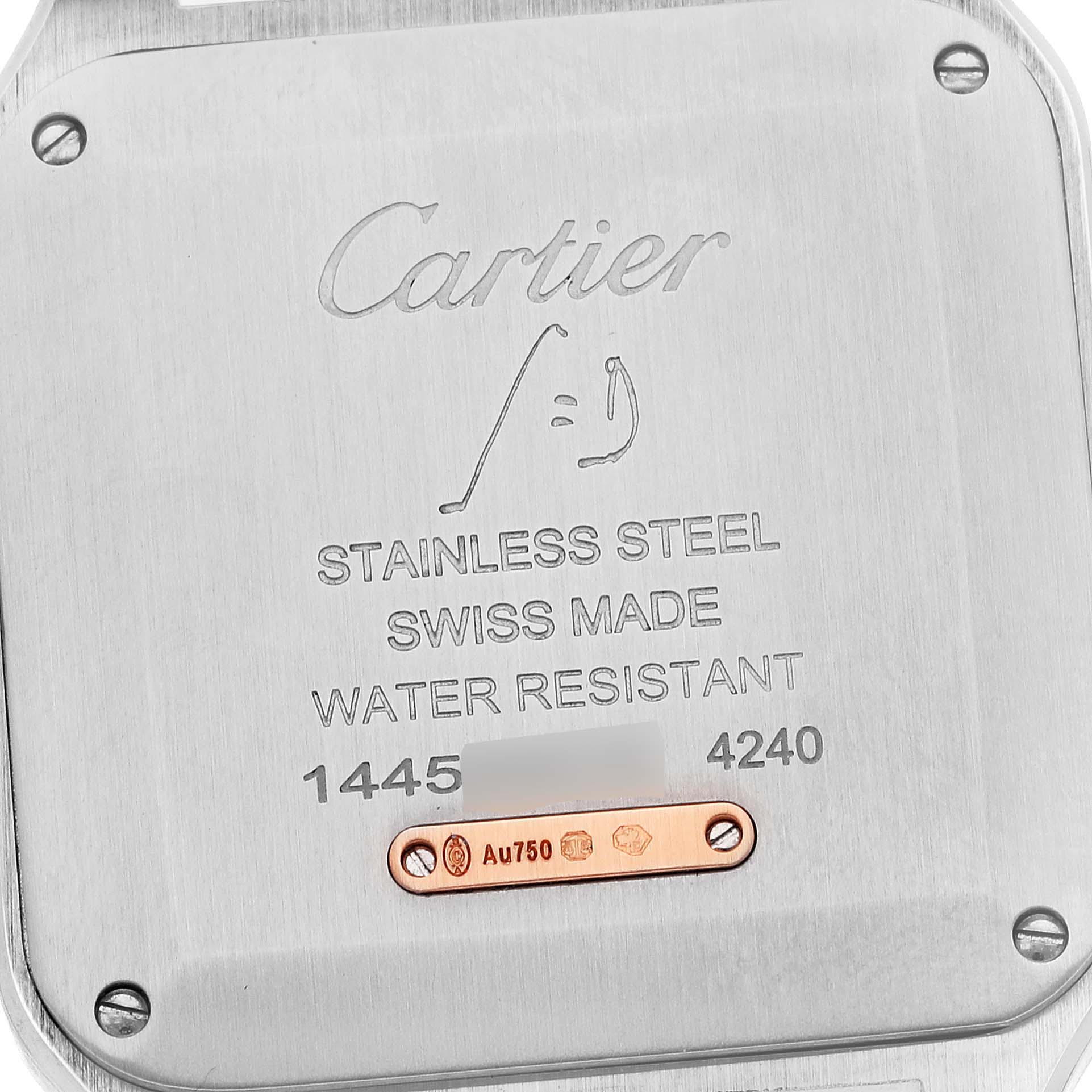 This image shows the case back of a Santos Dumont model watch by Cartier, featuring various engravings and a small gold plaque.