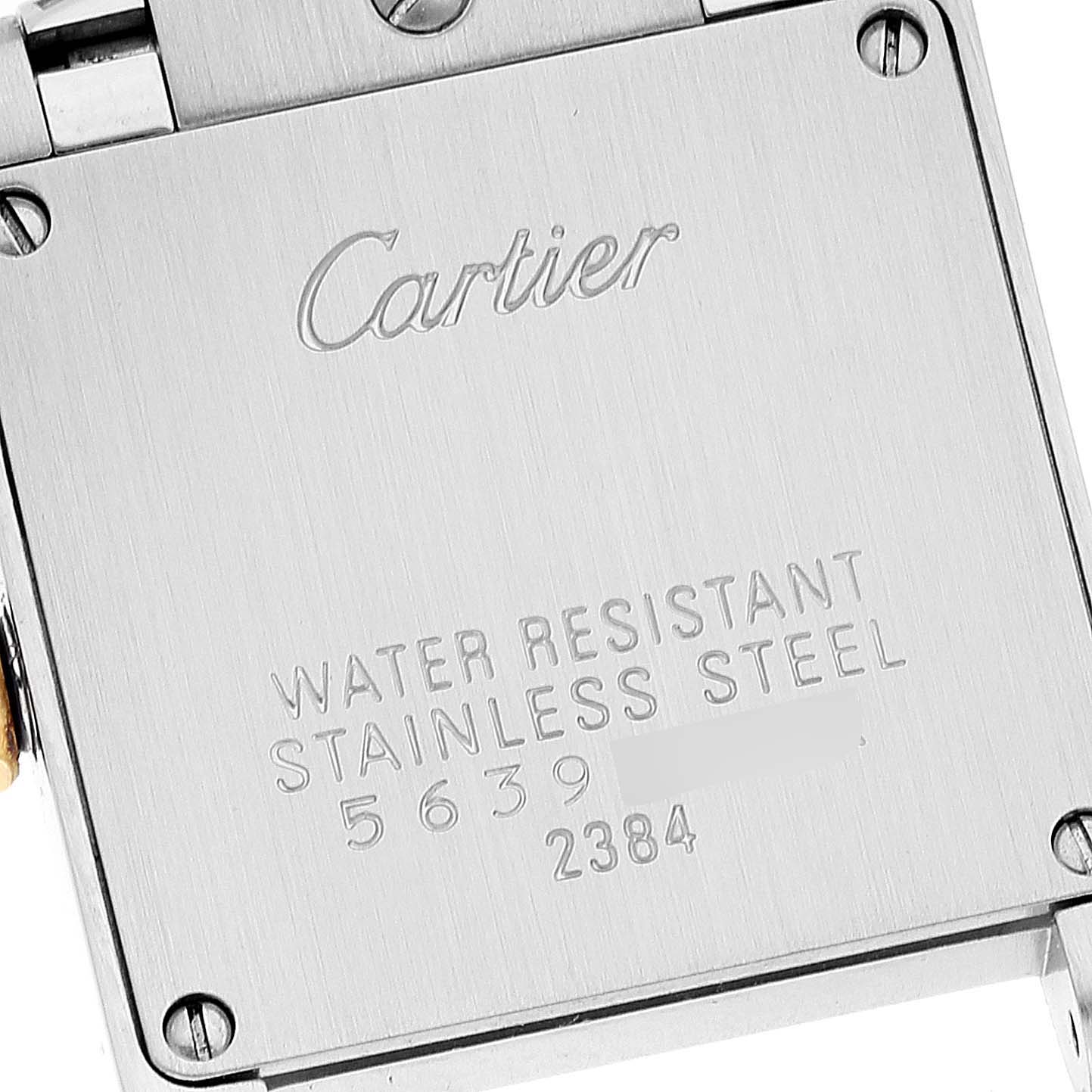 This image shows the back case of a Tank Francaise watch by Cartier at a close-up angle, displaying the brand, model information, and material details.