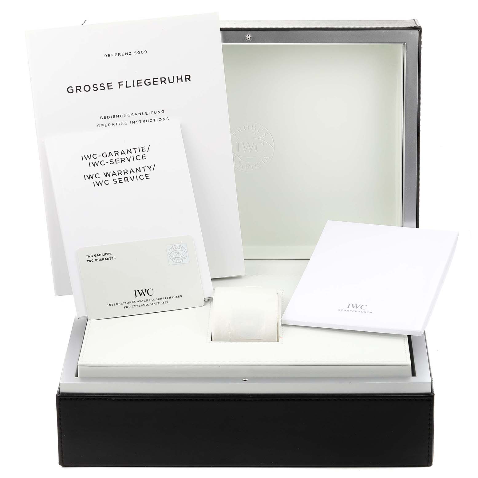 The image shows the box, operating instructions, warranty, and service documents of the IWC Pilot IW500908 Men's Stainless Steel Blue Dial IW500908 Men's Stainless Steel Blue Dial model watch.