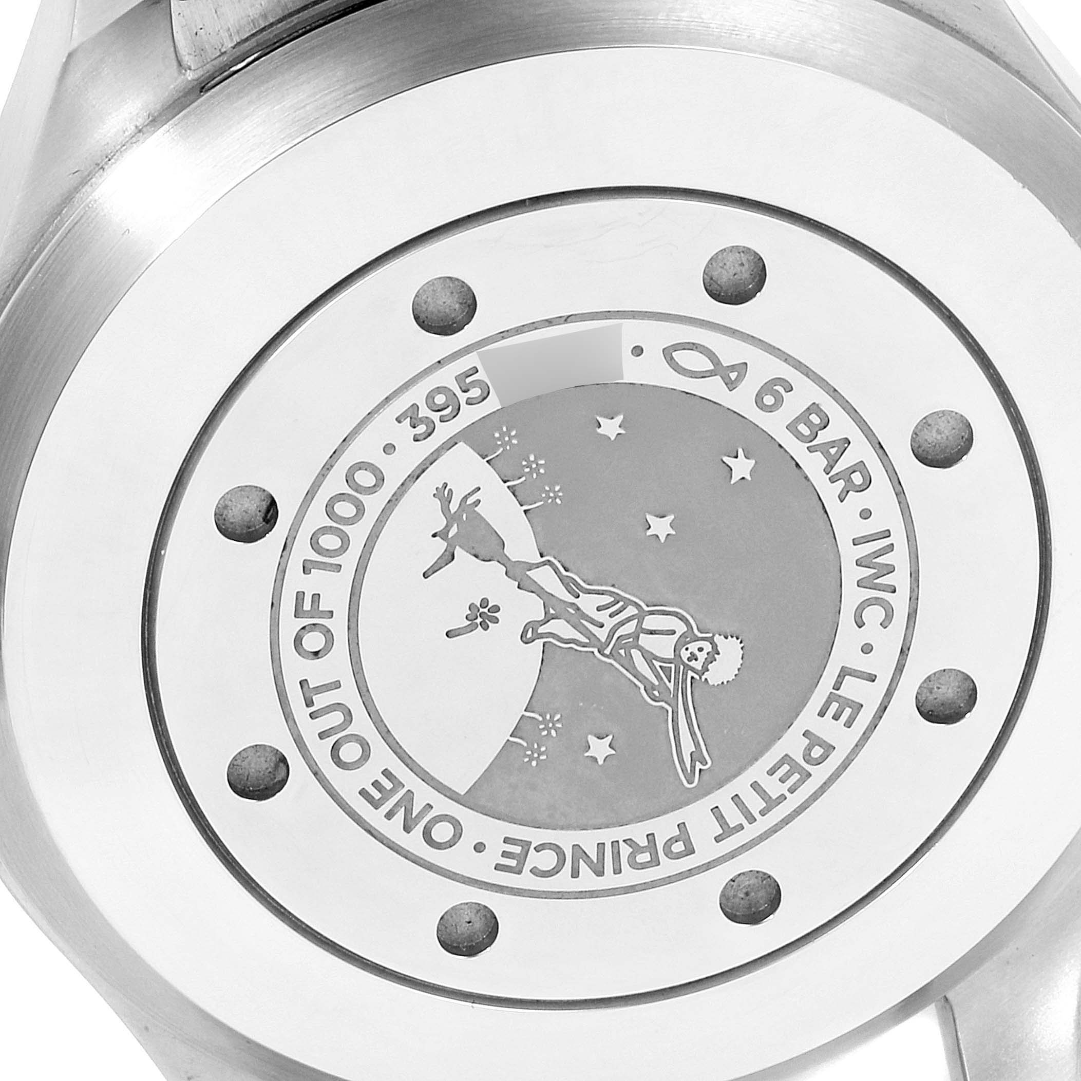 This image shows the back case of the IWC Pilot IW500908 Men's Stainless Steel Blue Dial IW500908 Men's Stainless Steel Blue Dial model watch, featuring an engraving of "Le Petit Prince" and various markings.
