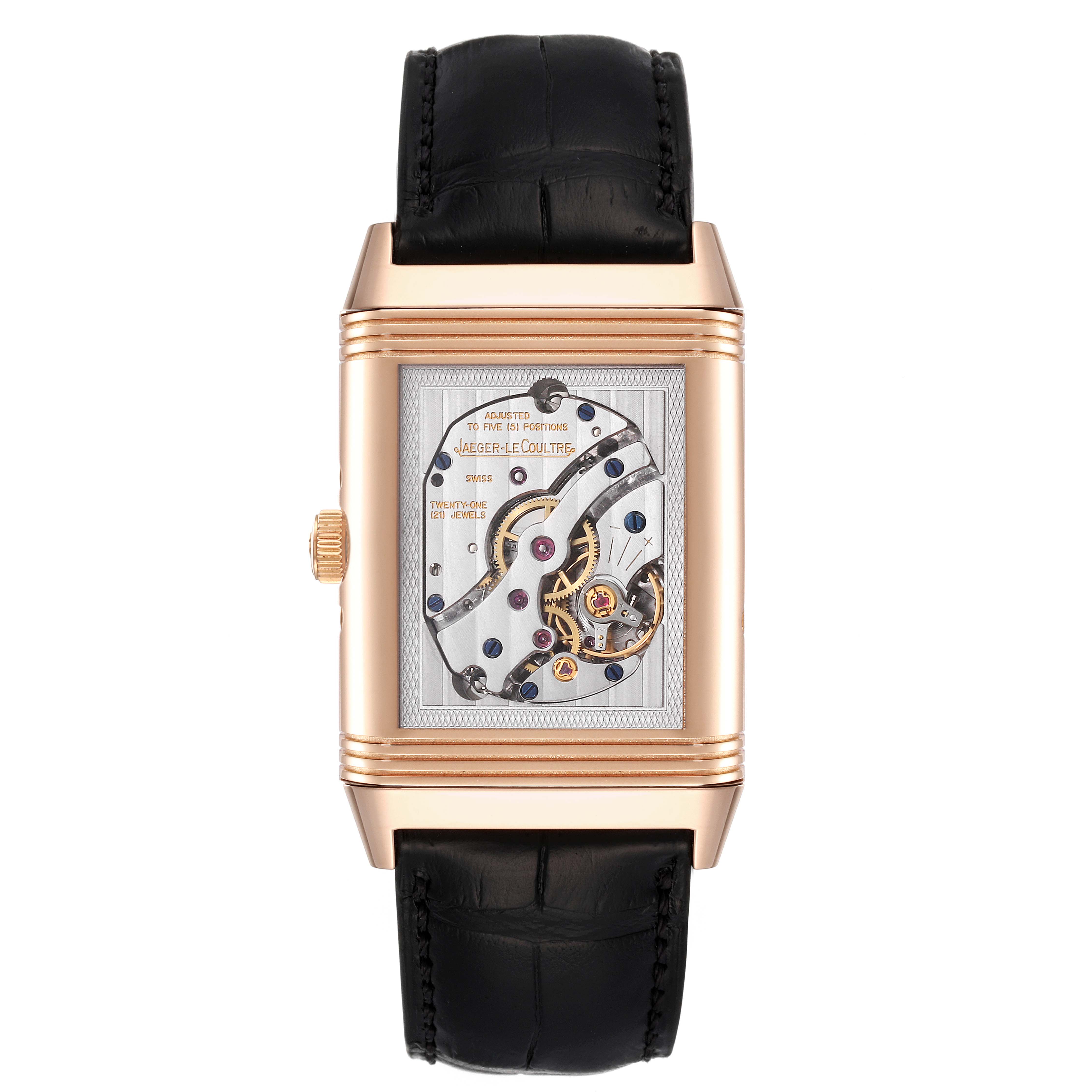 The image shows the reverse side of the Jaeger-LeCoultre Reverso watch, displaying its mechanical movement.