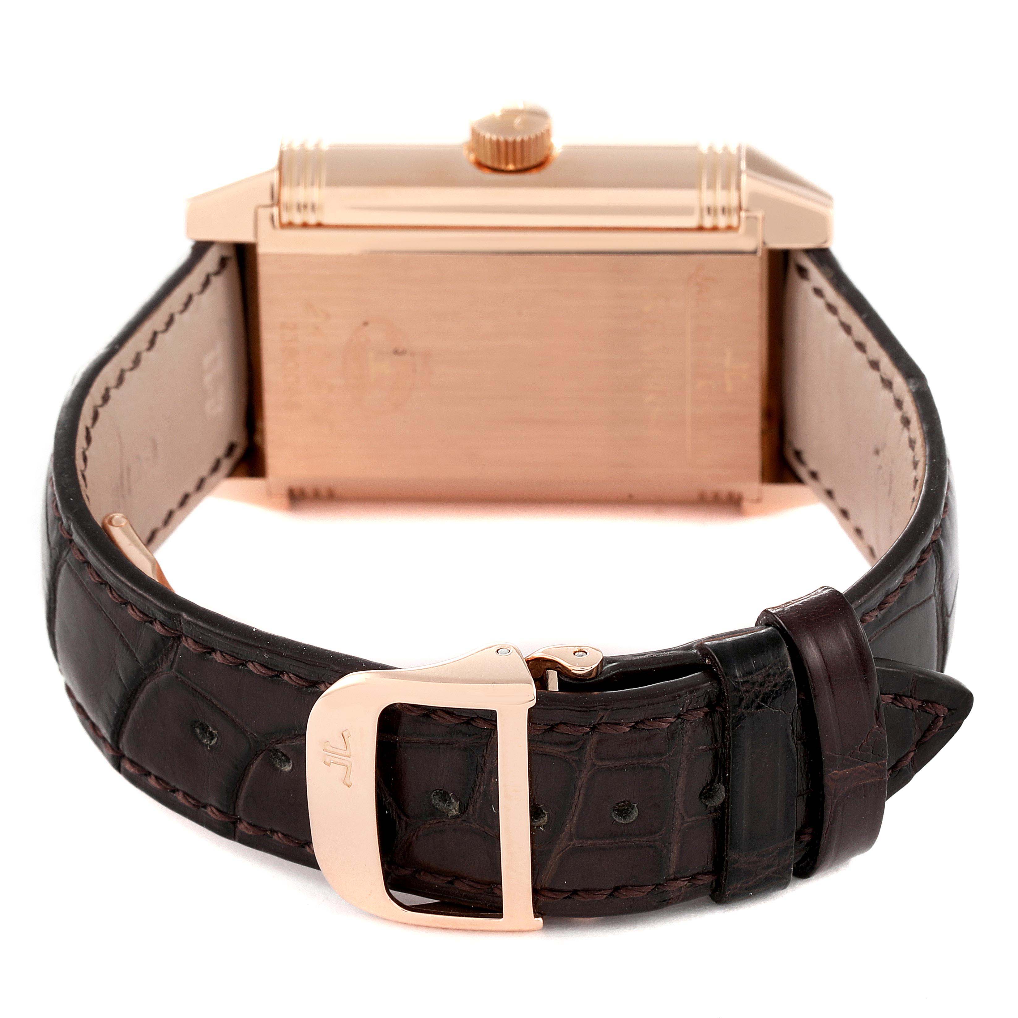 The image shows the back and side of the Jaeger-LeCoultre Reverso watch along with its leather strap and buckle.