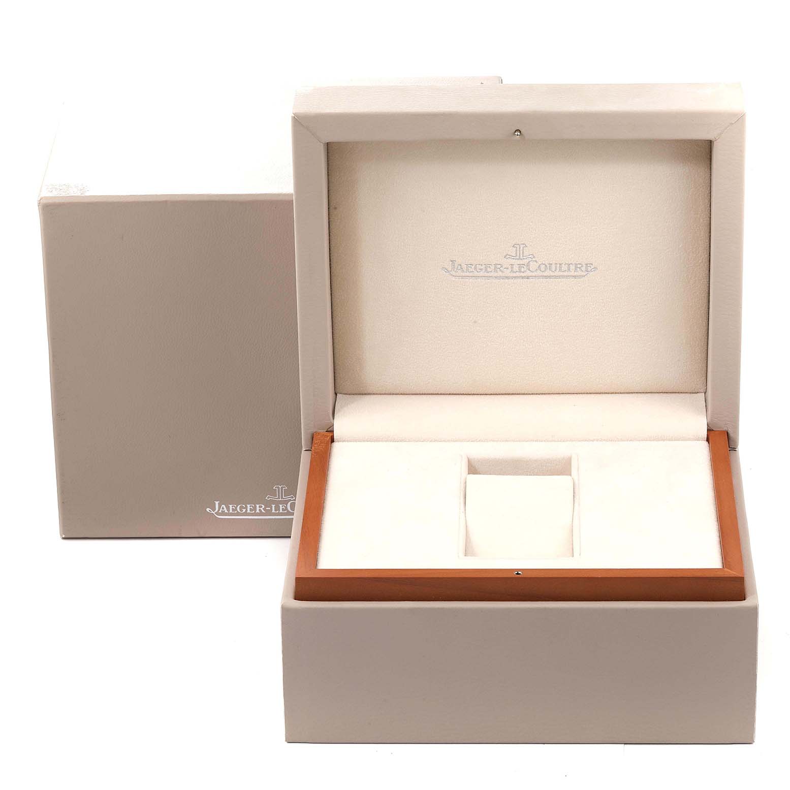 The image shows an open and empty Jaeger-LeCoultre Reverso watch box with compartments for the watch and accessories.