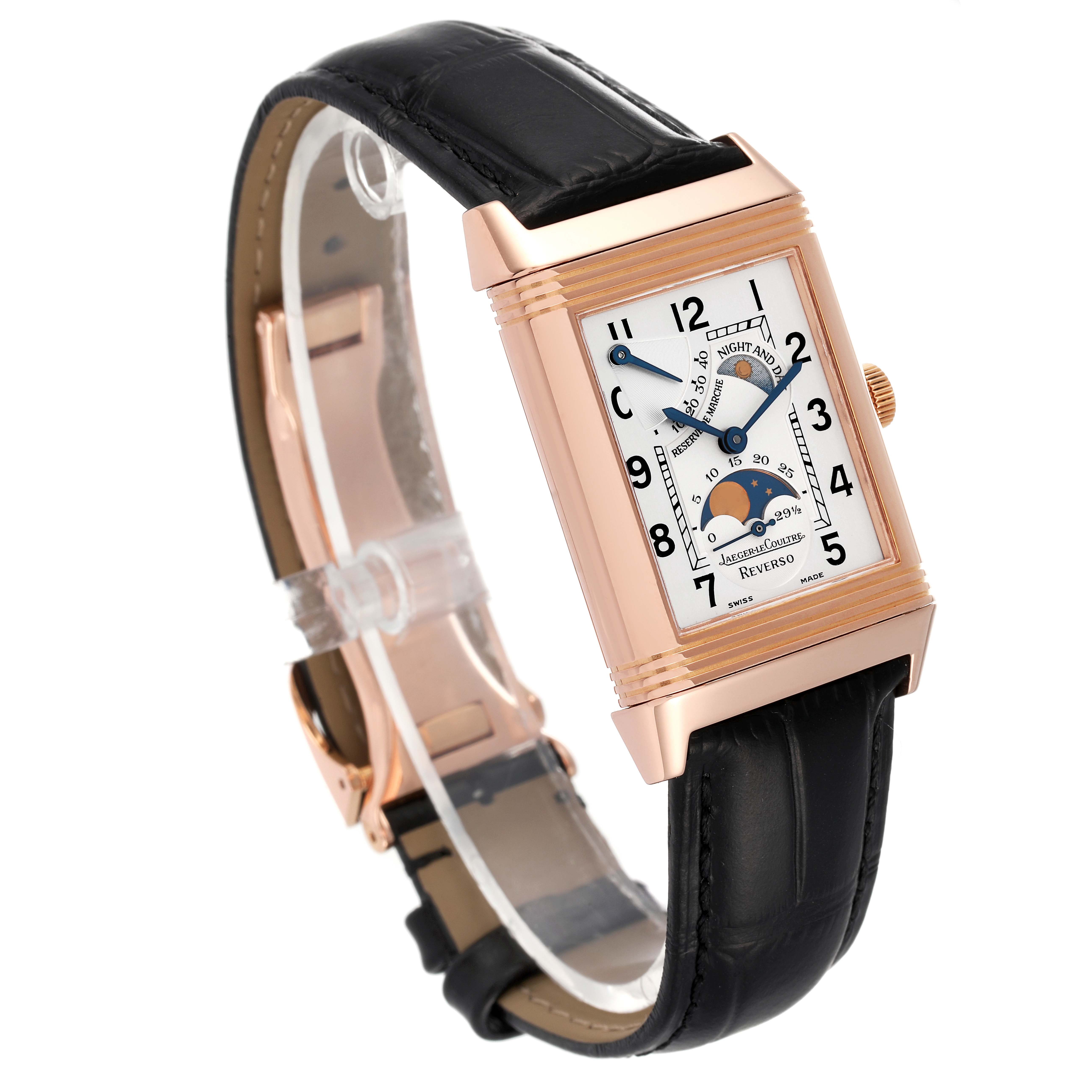 The image shows a Jaeger LeCoultre Reverso Q2752420 Men
s Rose Gold Silver Dial Q2752420 Men
s Rose Gold Silver Dial watch from an angled side view, showcasing its face, case, strap, and buckle.