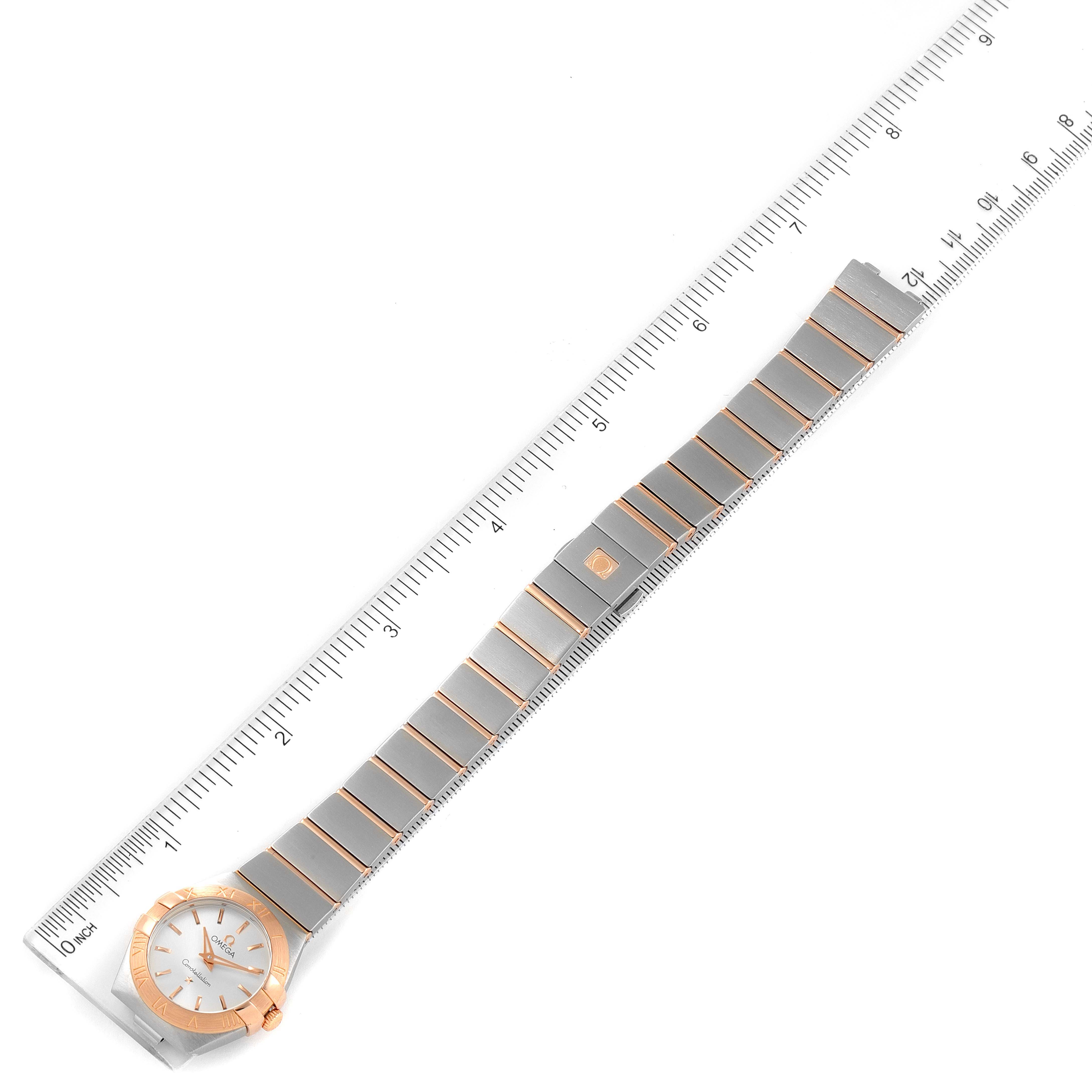 The image displays the Omega 123.20.24.60.02.001 Women's Steel and Gold (two tone) Silver Dial 123.20.24.60.02.001 Women's Steel and Gold (two tone) Silver Dial Constellation Steel Rose Gold Ladies Watch 123.20.24.60.02.001 laid flat next to a ruler.