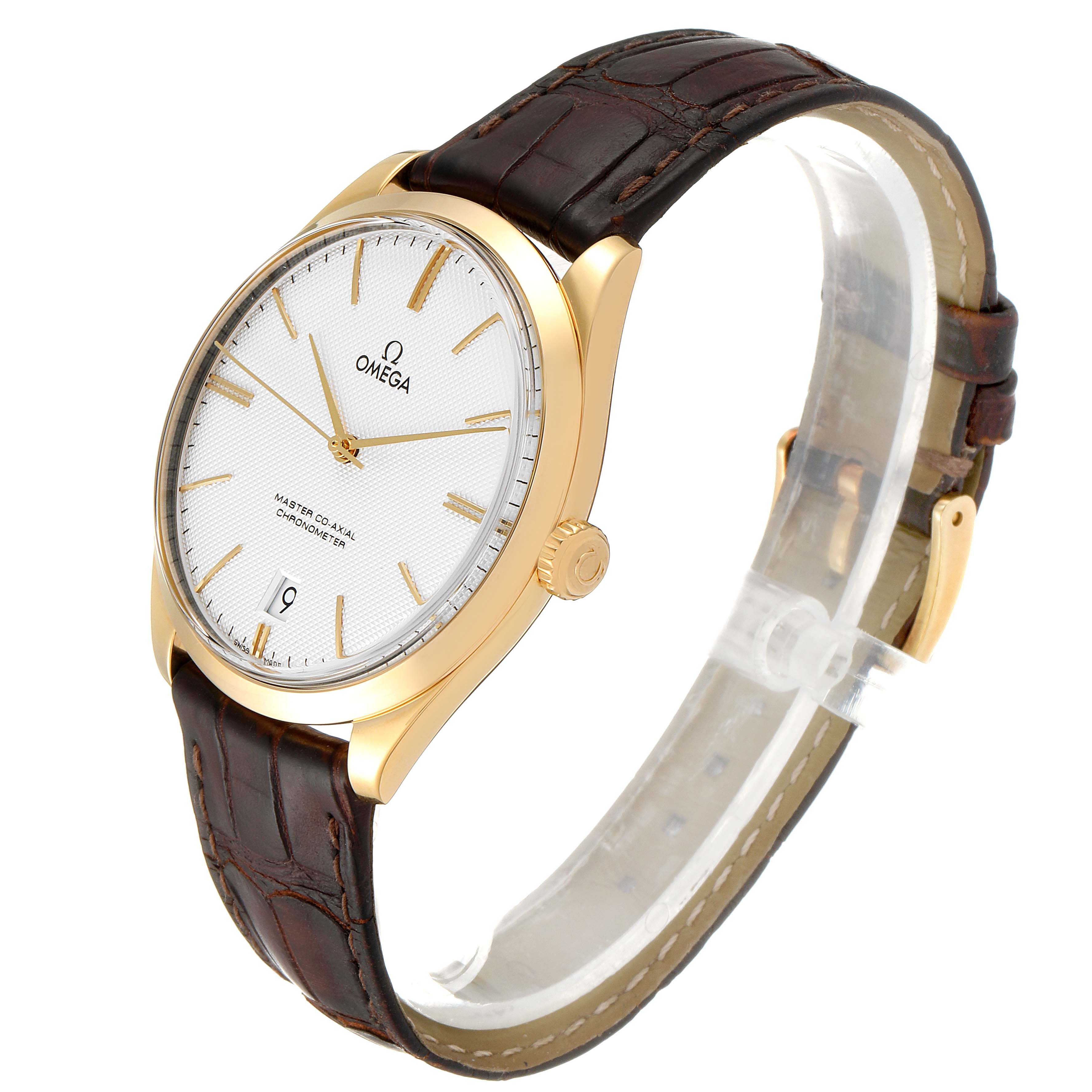 The image shows an angled view of an Omega De Ville 432.53.40.21.02.001 Men's Yellow Gold Silver Dial 432.53.40.21.02.001 Men's Yellow Gold Silver Dial watch, highlighting its gold case, white dial, and brown leather strap.