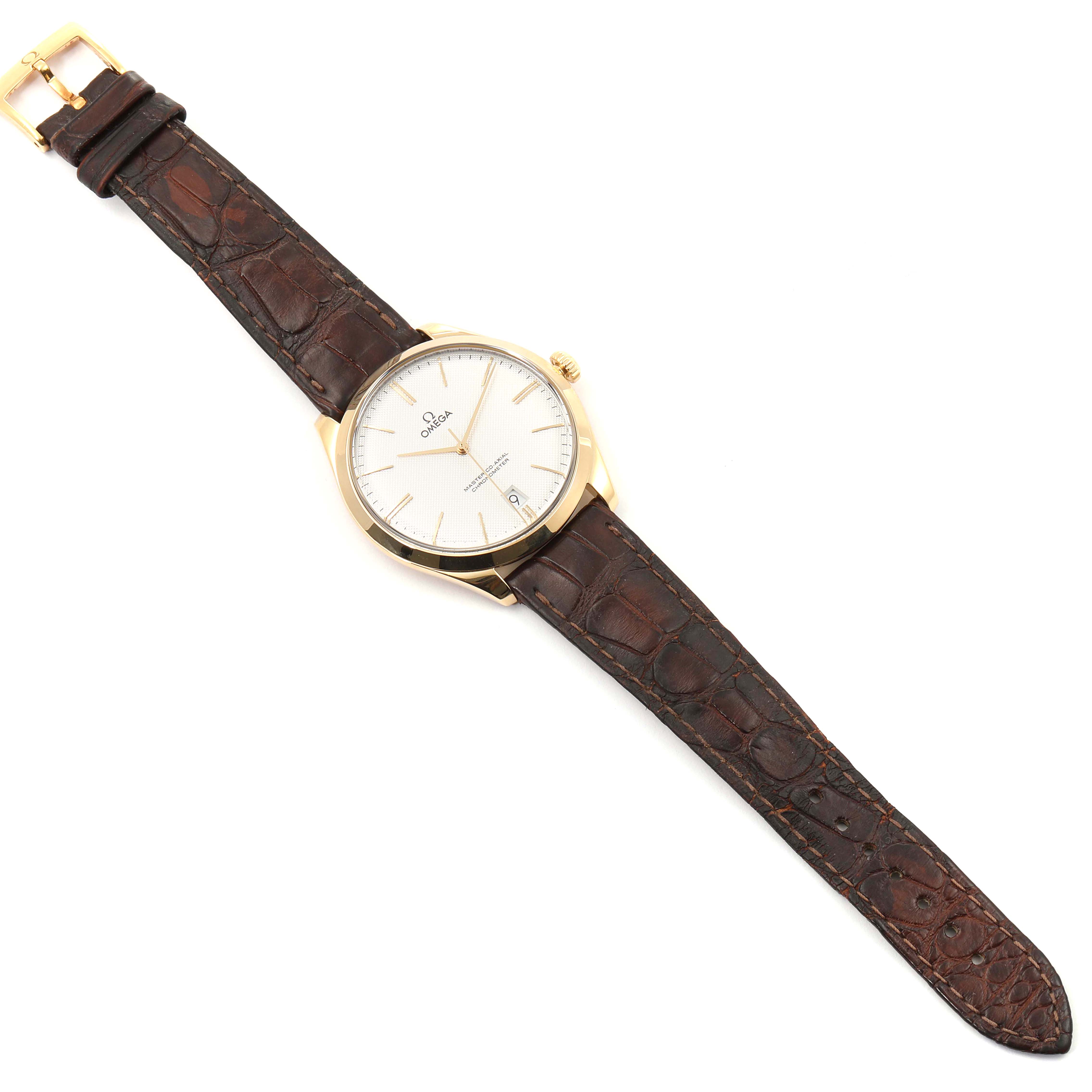 The image shows an overhead view of an Omega De Ville 432.53.40.21.02.001 Men's Yellow Gold Silver Dial 432.53.40.21.02.001 Men's Yellow Gold Silver Dial watch featuring a brown leather strap and a gold case.