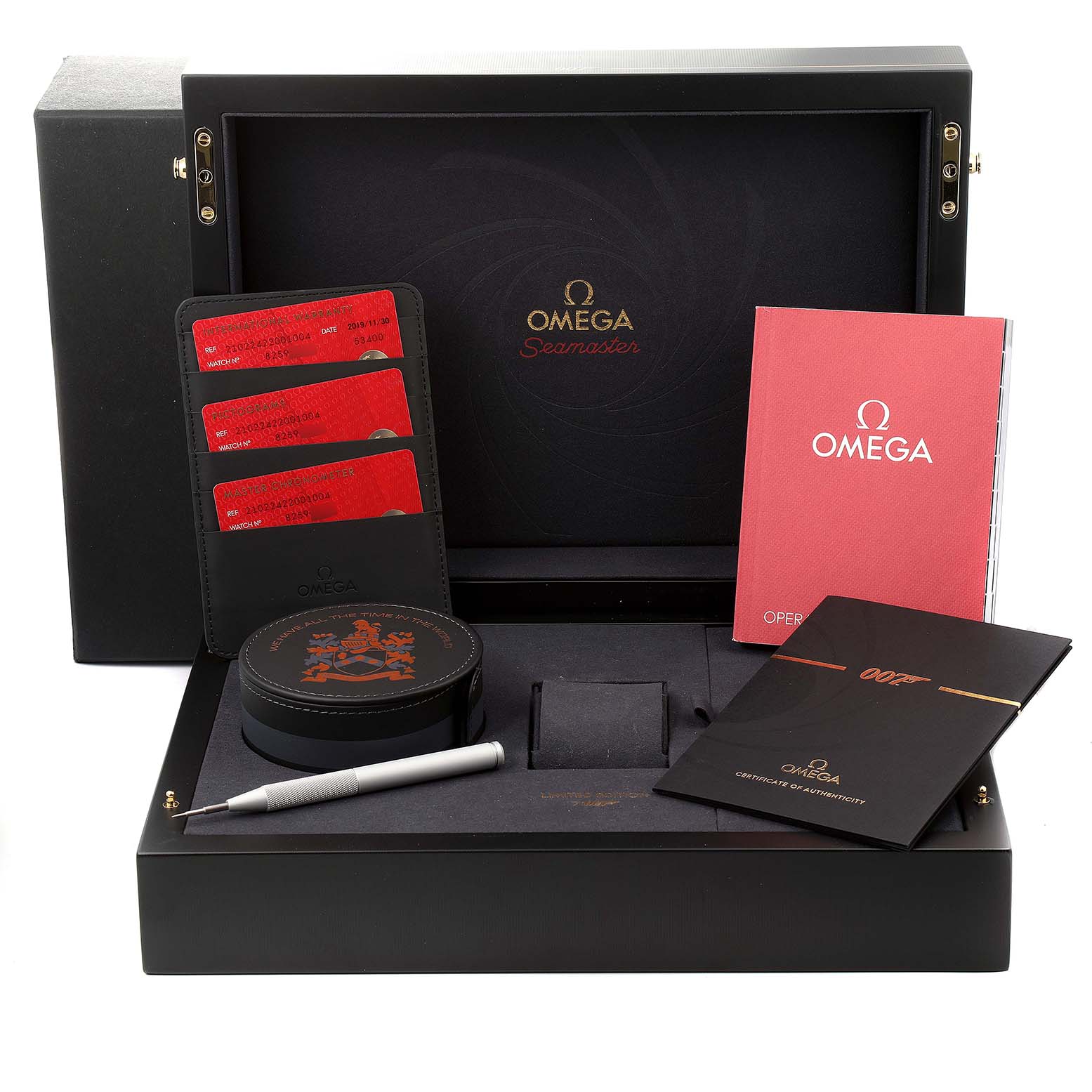 The image shows an Omega Seamaster 210.22.42.20.01.004 Men's Stainless Steel Black Dial 210.22.42.20.01.004 Men's Stainless Steel Black Dial watch box at an angle displaying its contents including manuals, cards, a tool, and a case.