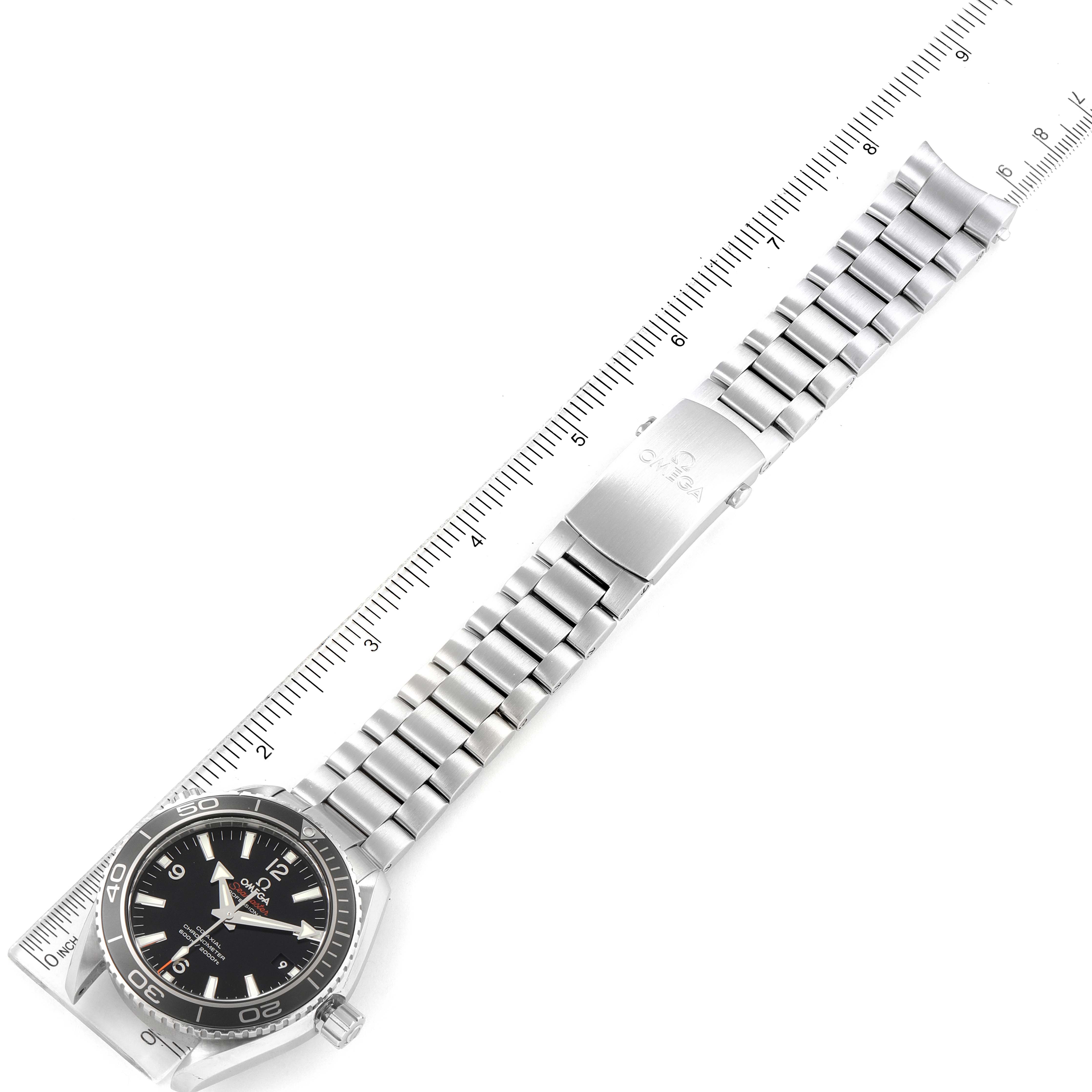 The Omega Planet Ocean 232.30.42.21.01.003 Men
s Stainless Steel Black Dial 232.30.42.21.01.003 Men
s Stainless Steel Black Dial watch is displayed horizontally with a stainless steel bracelet and clasp, aligned with a ruler for scale.
