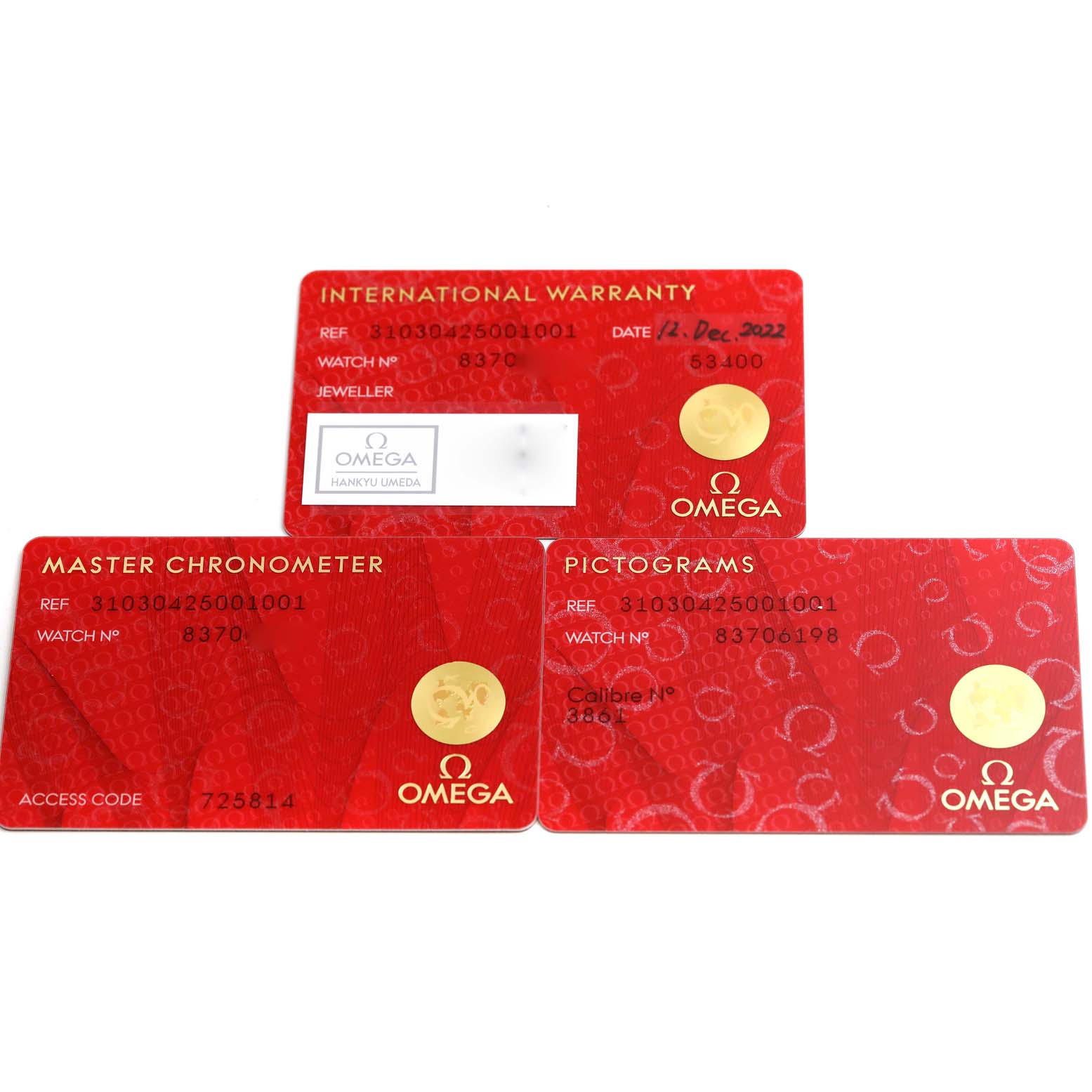 The image shows warranty cards for an Omega Speedmaster 310.30.42.50.01.001 Men
s Stainless Steel Black Dial 310.30.42.50.01.001 Men
s Stainless Steel Black Dial watch, including Pictograms, Master Chronometer, and International Warranty cards.