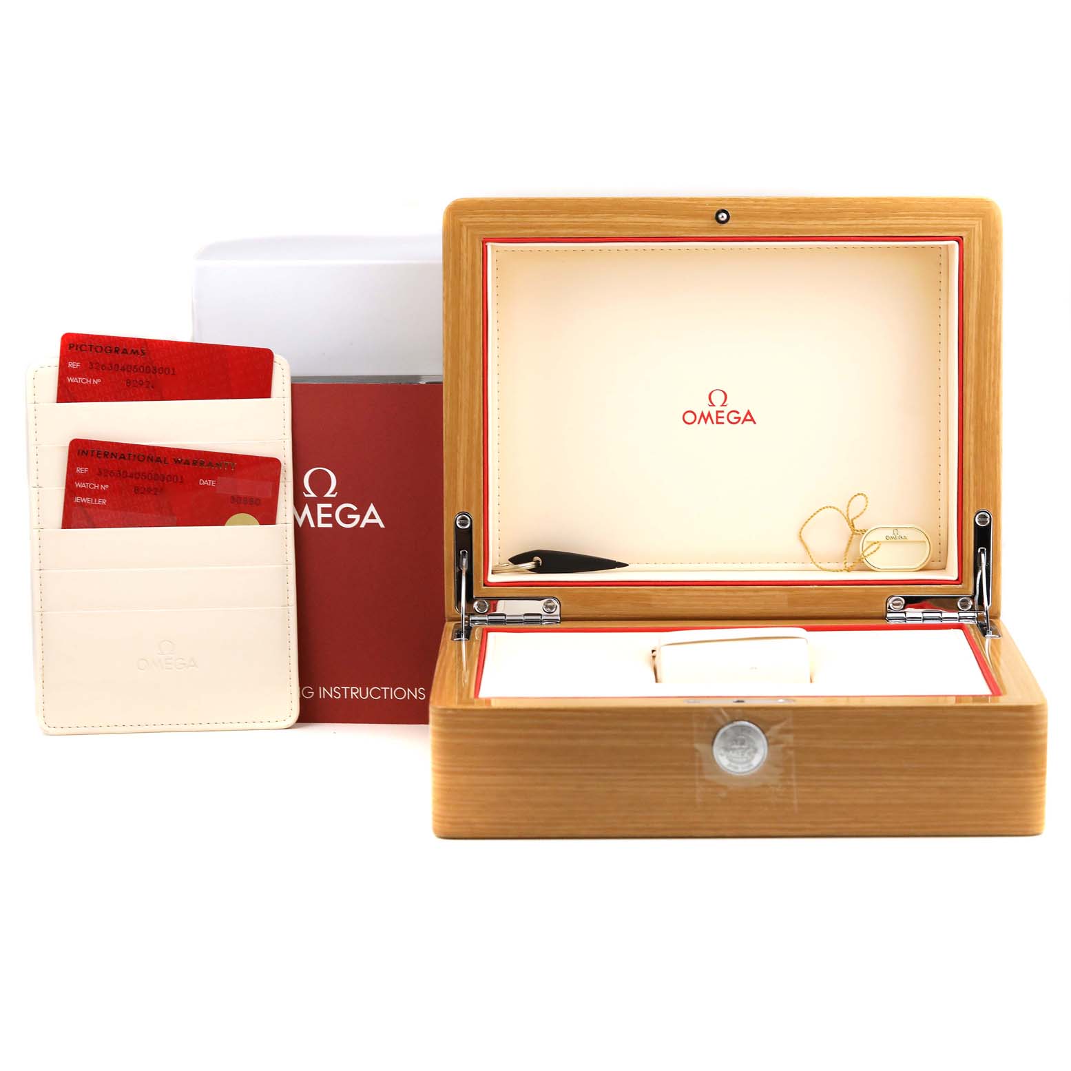 The image shows an open Omega Speedmaster 326.30.40.50.03.001 Men
s Stainless Steel Blue Dial 326.30.40.50.03.001 Men
s Stainless Steel Blue Dial watch box, warranty cards, and instructional booklet from a front-facing perspective.