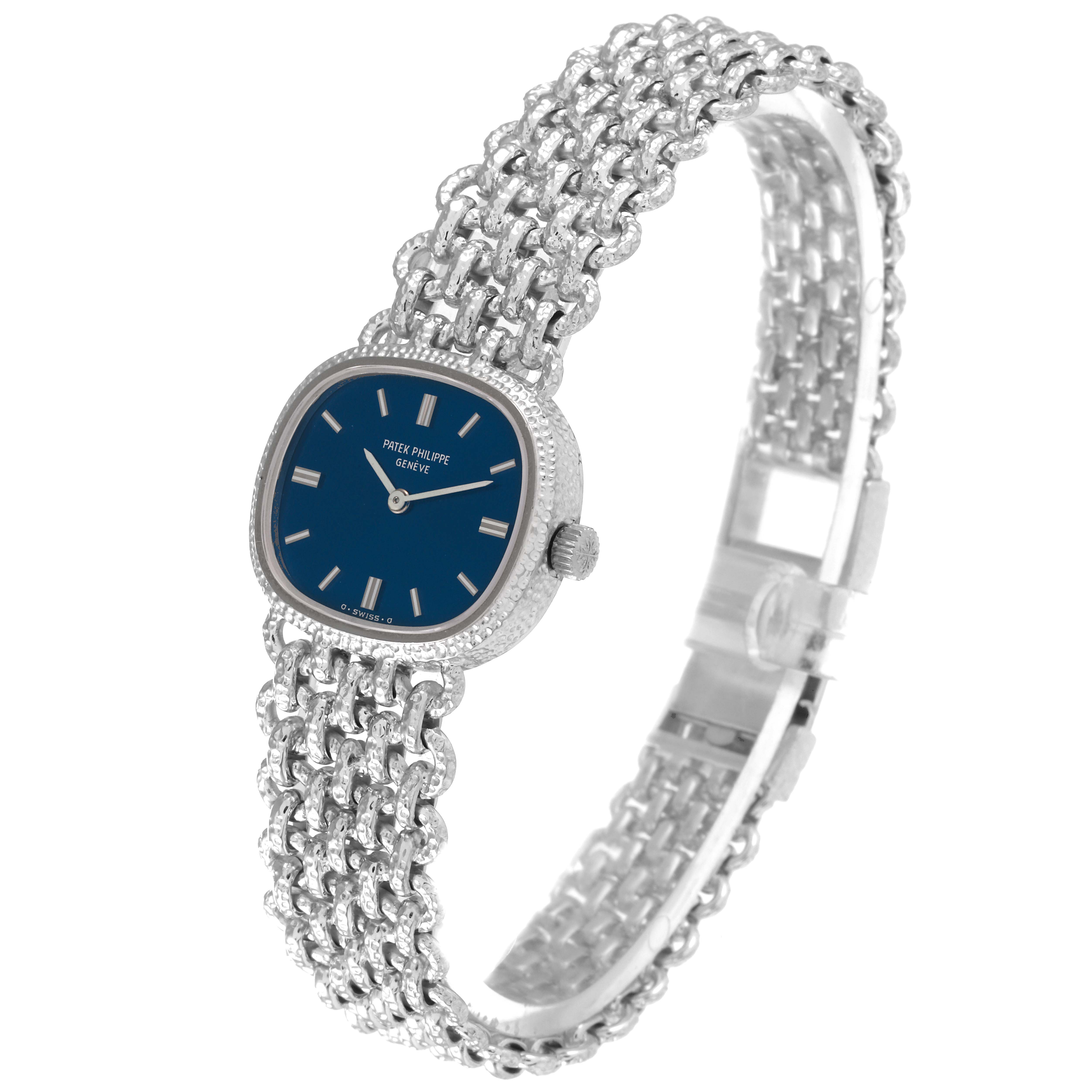 The image shows a Patek Philippe Golden Ellipse 4133 Women's White Gold Blue Dial 4133 Women's White Gold Blue Dial watch with a blue dial and metal bracelet from a side angle.