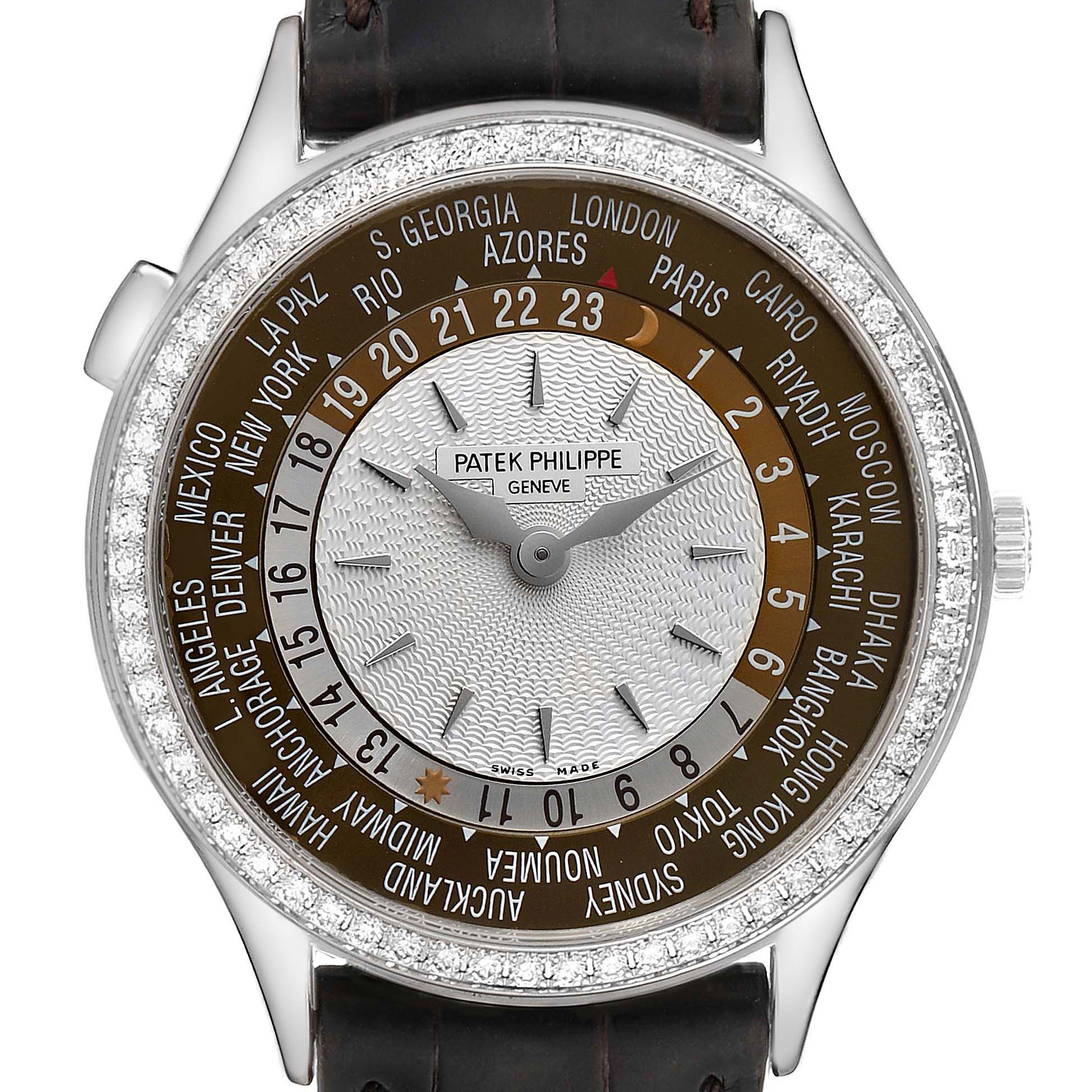 The image shows a front view of a Patek Philippe Complications 7130G-001 Men's White Gold Brown Dial 7130G-001 Men's White Gold Brown Dial watch displaying its world time dial and leather strap.