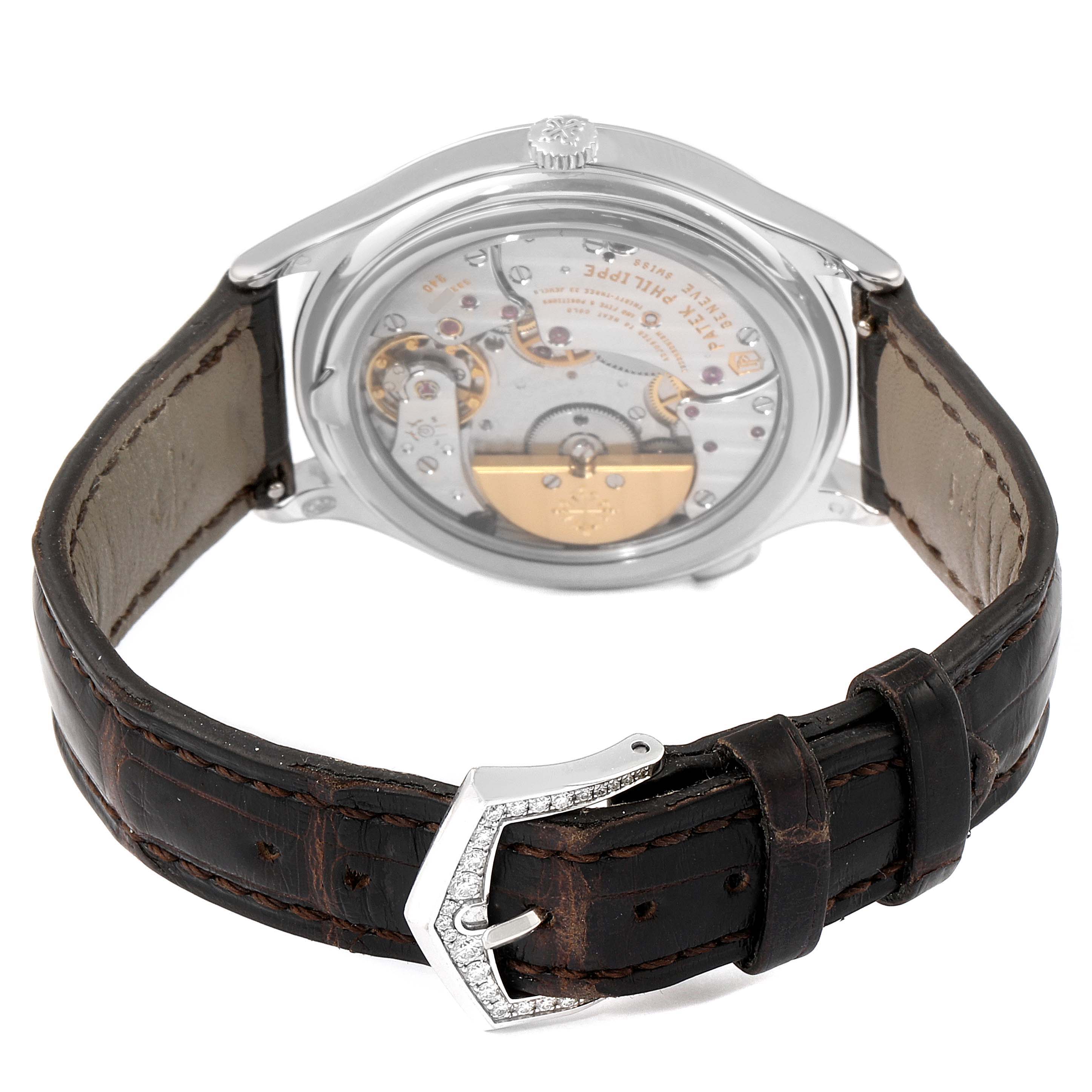 The image shows the back of a Patek Philippe Complications 7130G-001 Men's White Gold Brown Dial 7130G-001 Men's White Gold Brown Dial watch, highlighting the movement and leather strap.