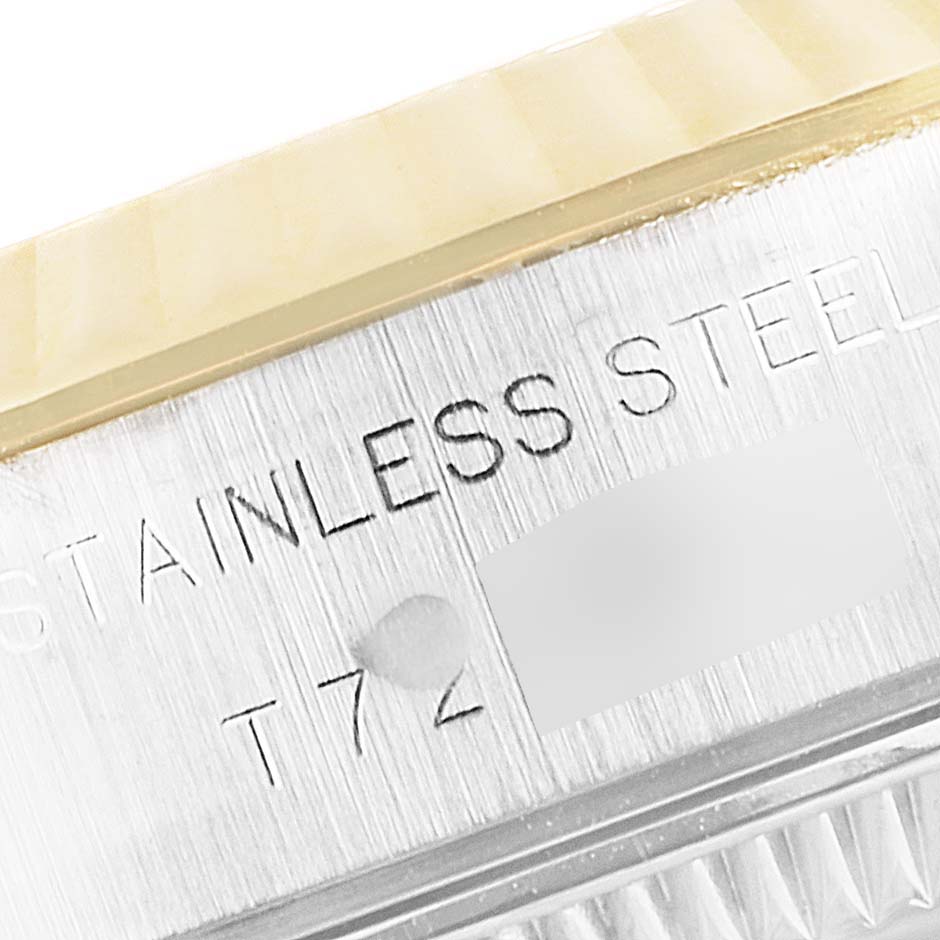 The image shows a close-up of the edge of the case and bezel of a Rolex Datejust 69173 Women
s Steel and Gold (two tone) Blue Dial 69173 Women
s Steel and Gold (two tone) Blue Dial, highlighting the "Stainless Steel" engraving.