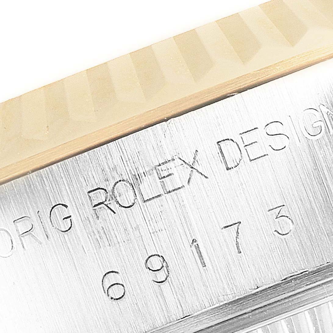 This close-up image shows the engraved side of the Rolex Datejust 69173 Women
s Steel and Gold (two tone) Blue Dial 69173 Women
s Steel and Gold (two tone) Blue Dial watch case, including the model number and design details.