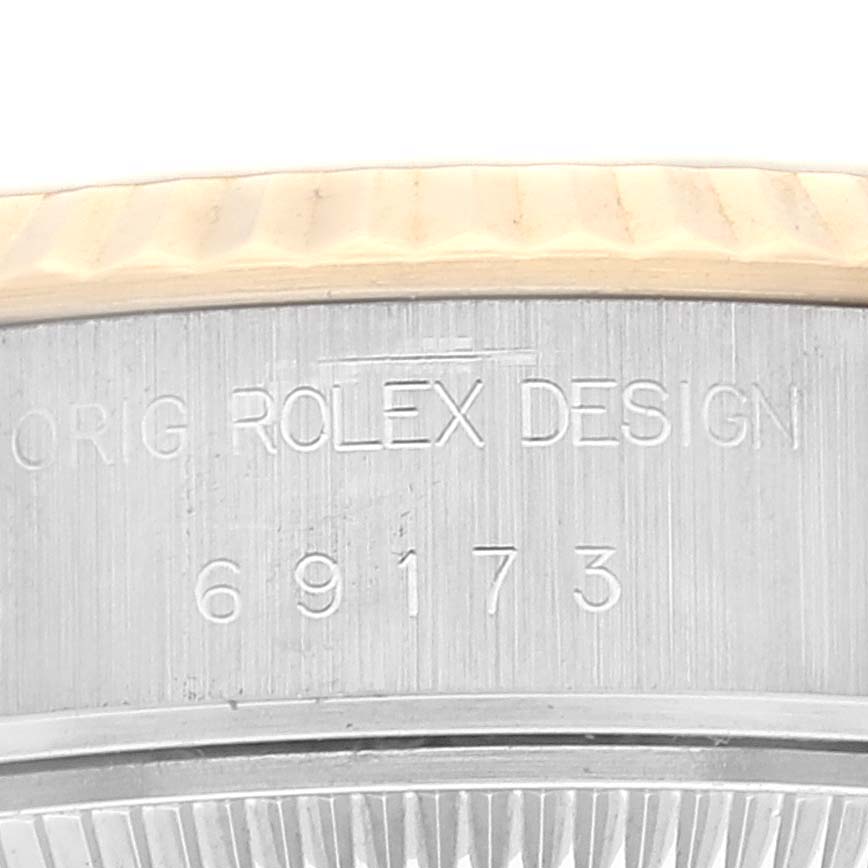 This image shows a close-up of the case number and part of the bezel of a Rolex Datejust 69173 Women's Steel and Gold (two tone) White Dial 69173 Women's Steel and Gold (two tone) White Dial watch.