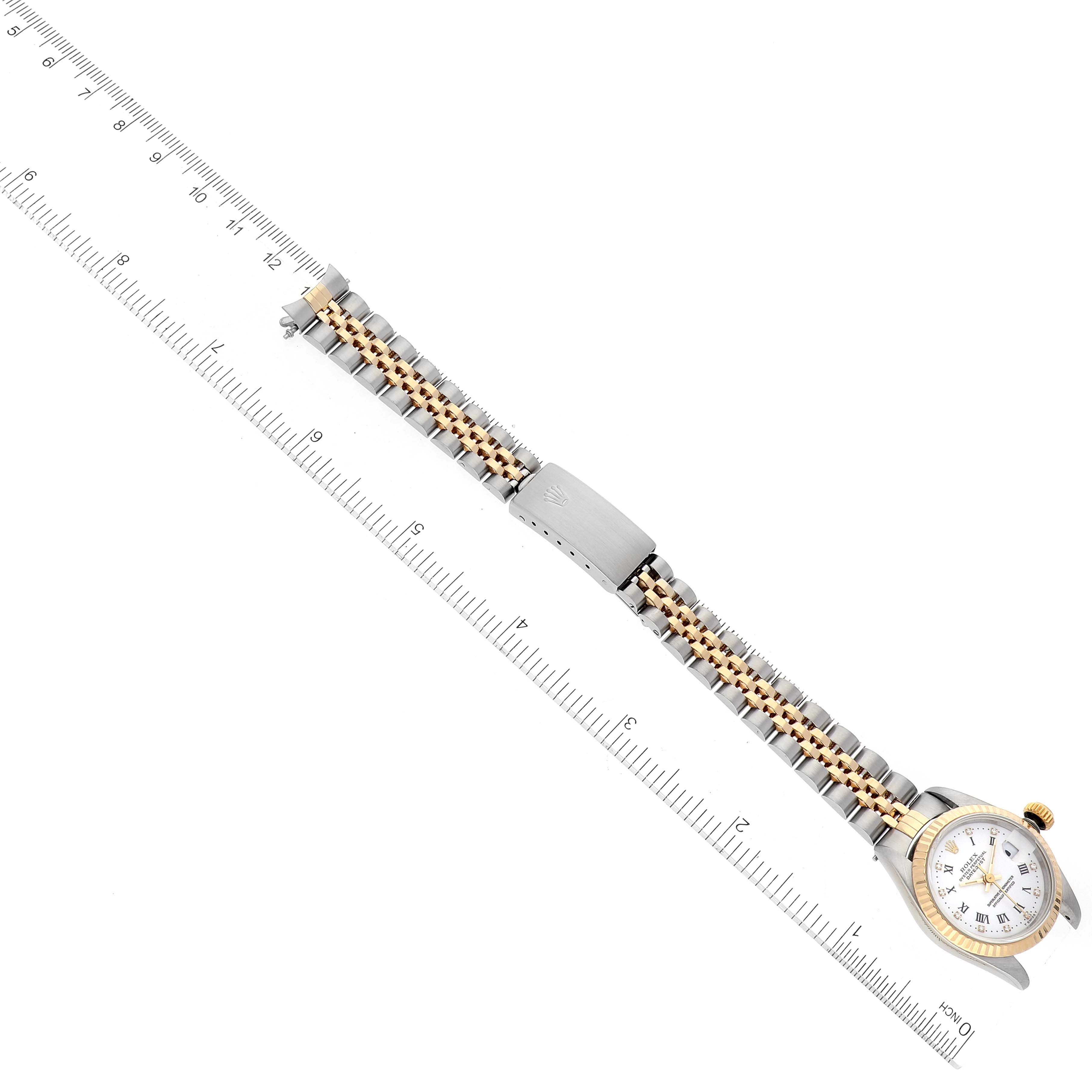 The image shows a Rolex Datejust 69173 Women's Steel and Gold (two tone) White Dial 69173 Women's Steel and Gold (two tone) White Dial watch laid flat alongside a ruler, displaying the entire bracelet and watch face.