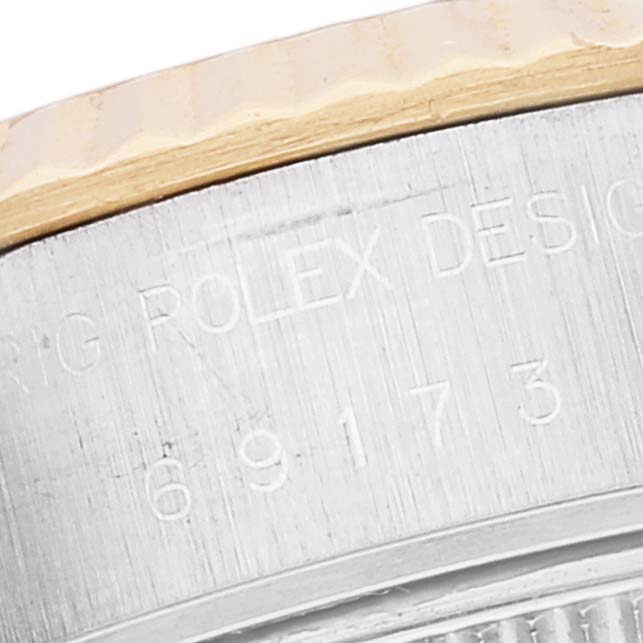 This image shows a close-up of the engraved side casing of a Rolex Datejust 69173 Women's Steel and Gold (two tone) White Dial 69173 Women's Steel and Gold (two tone) White Dial watch.