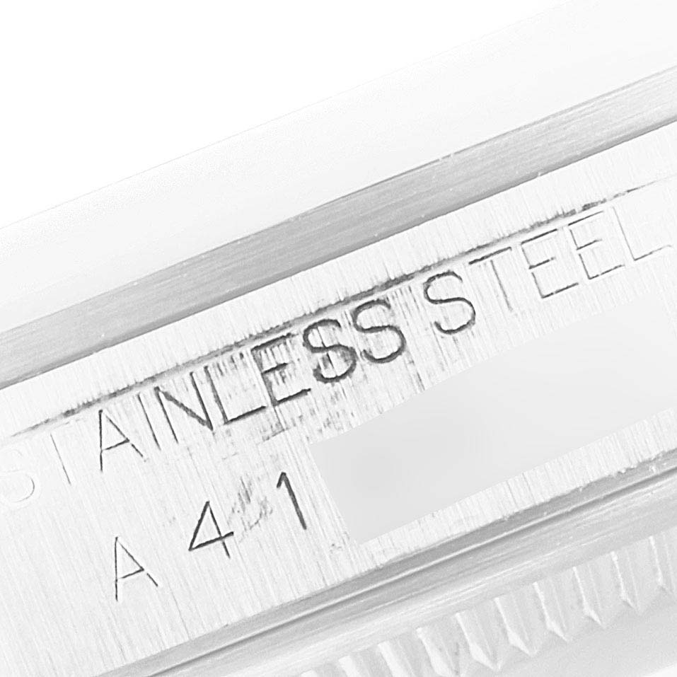A close-up of the Rolex Datejust 16200 Men's Stainless Steel Silver Dial 16200 Men's Stainless Steel Silver Dial watch shows an engraving on the watch case indicating "STAINLESS STEEL."