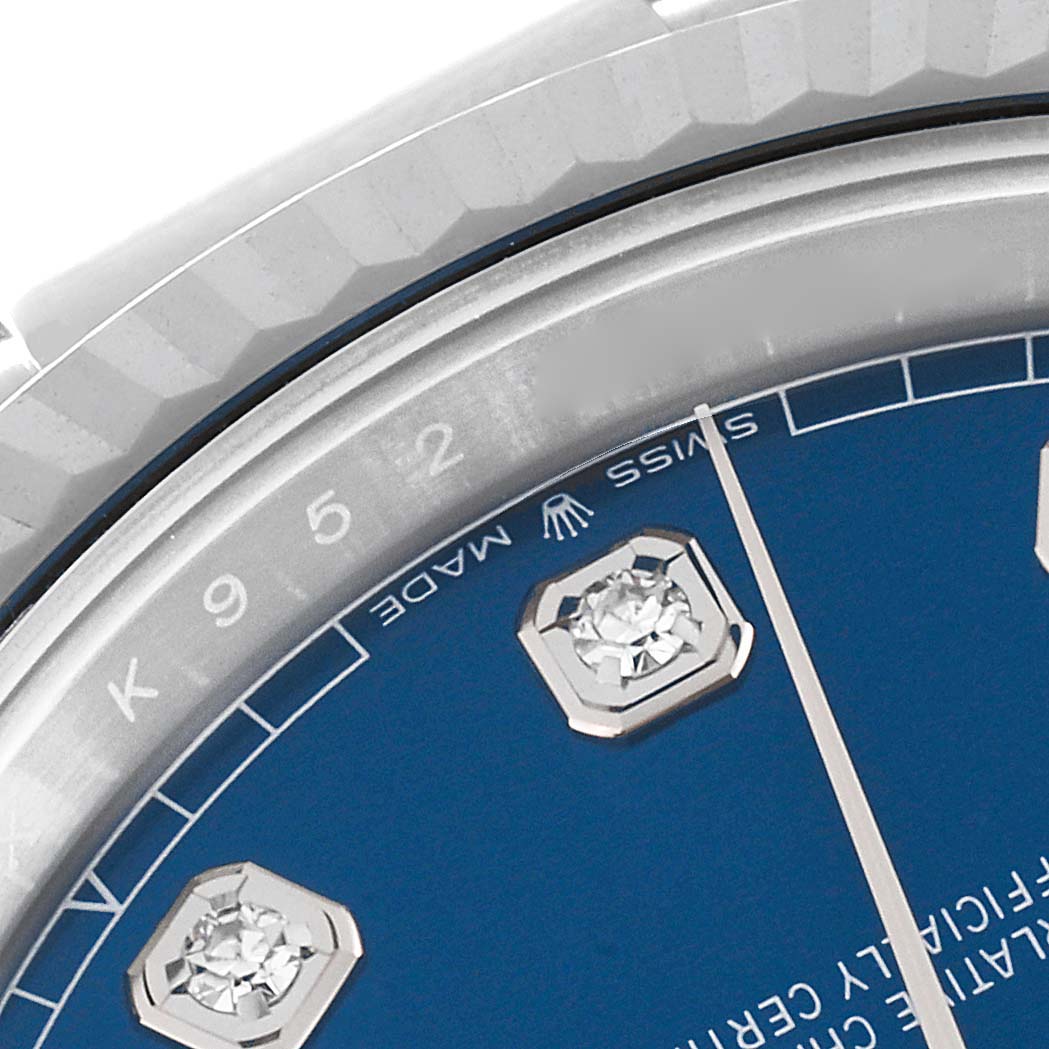 This close-up image of the Rolex Datejust 41 126334 Men
s Stainless Steel Blue Dial 126334 Men
s Stainless Steel Blue Dial watch shows part of the blue dial with diamond hour markers and the bezel.