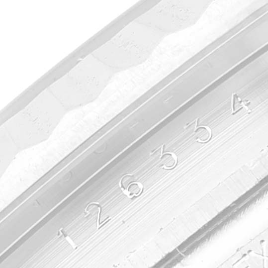 The image shows a close-up angled view of the Rolex Datejust 41 126334 Men
s Stainless Steel Blue Dial 126334 Men
s Stainless Steel Blue Dial model
s fluted bezel and rehaut with engraved numbers.