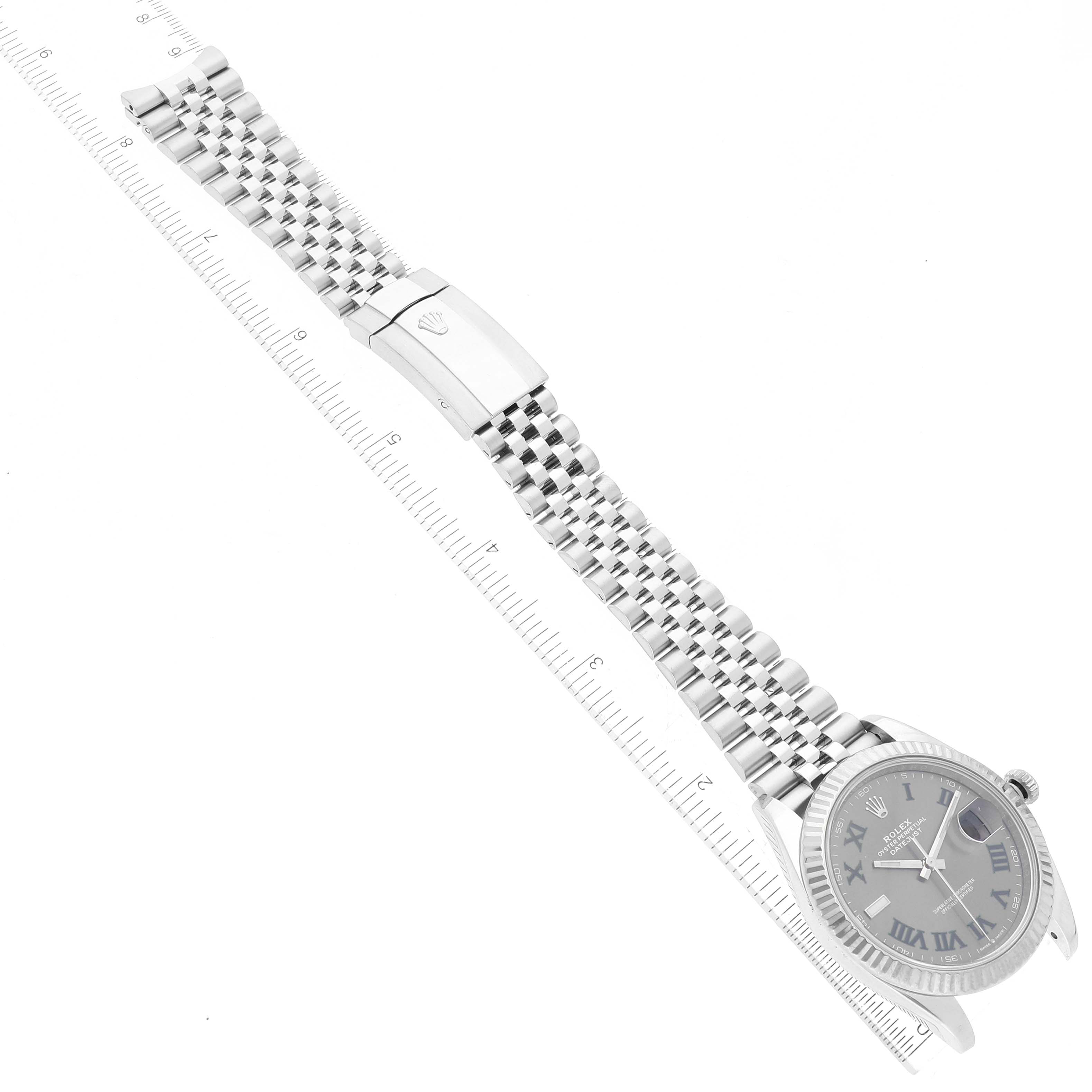 This image shows a Rolex Datejust 41 126334 Men
s Stainless Steel Grey Dial 126334 Men
s Stainless Steel Grey Dial watch laying flat with its face, bracelet, and clasp visible, alongside a ruler for scale.