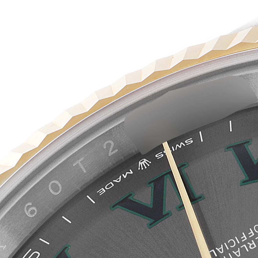 This close-up angle of the Rolex Datejust 41 126333 Men's Steel and Gold (two tone) Grey Dial 126333 Men's Steel and Gold (two tone) Grey Dial model shows the edge of the bezel, part of the dial, and the minute hand.