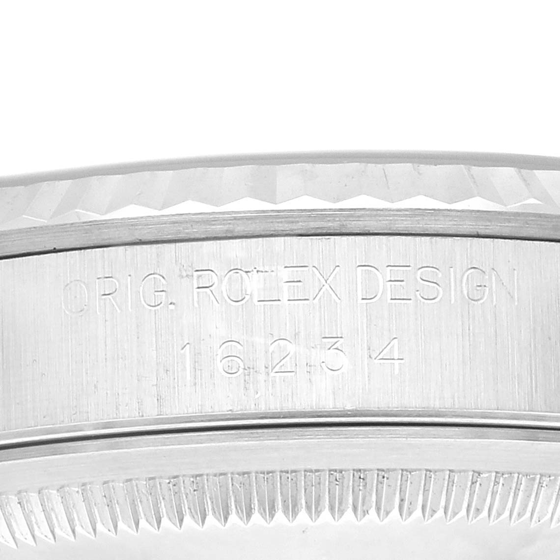 The image shows a close-up of the edge and engraving on the side of a Rolex Datejust 16234 Men's Stainless Steel Blue Dial 16234 Men's Stainless Steel Blue Dial watch bezel.