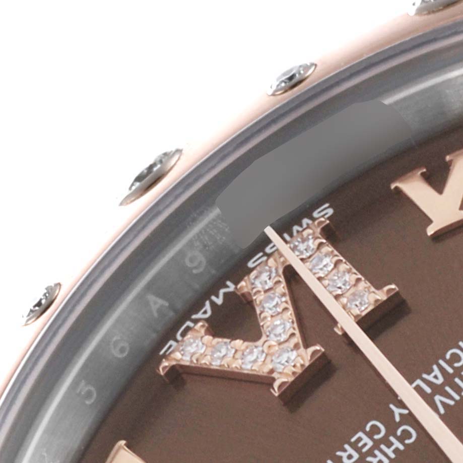 The image shows a close-up angle of a Mid-Size Rolex watch's bezel and part of the dial with Roman numeral markers.