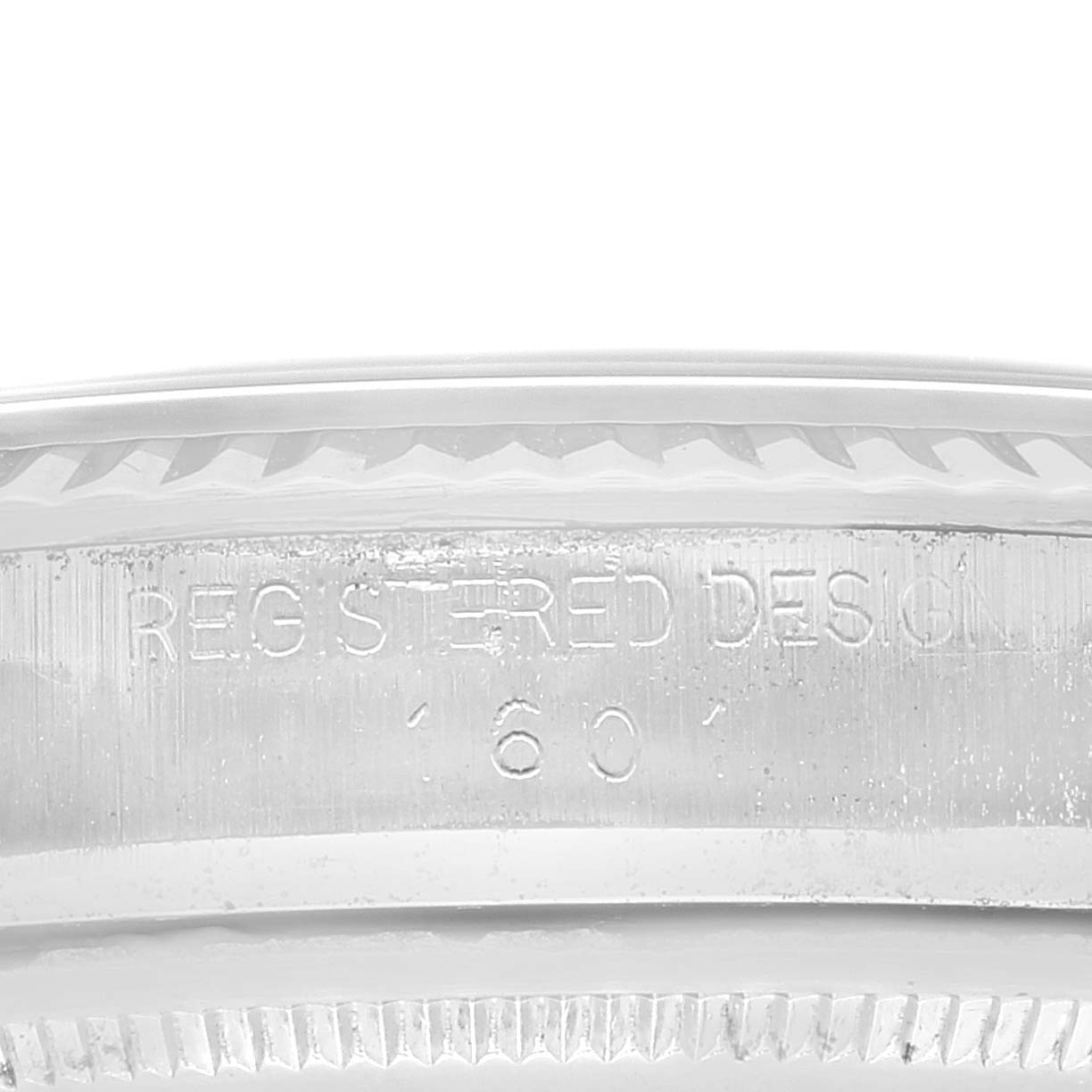 This image shows a close-up angle of the bezel and engraved serial number of the Rolex Vintage Collection 1601 Men's Stainless Steel Grey Dial 1601 Men's Stainless Steel Grey Dial watch.