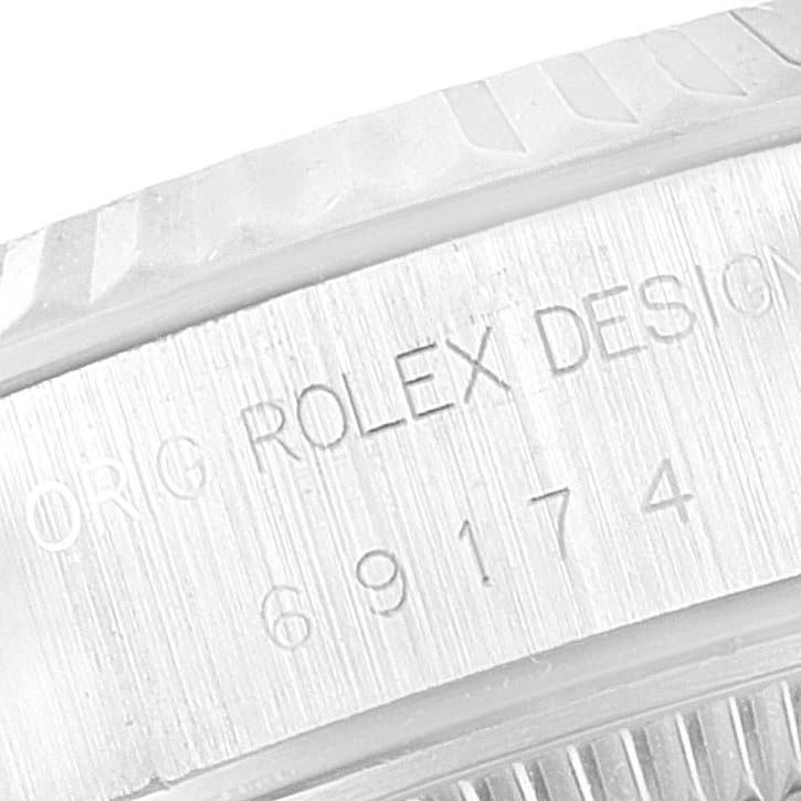 The image shows a close-up of the engraved bezel and inner case details of a Rolex Datejust 69174 Women
s Stainless Steel Silver Dial 69174 Women
s Stainless Steel Silver Dial watch.