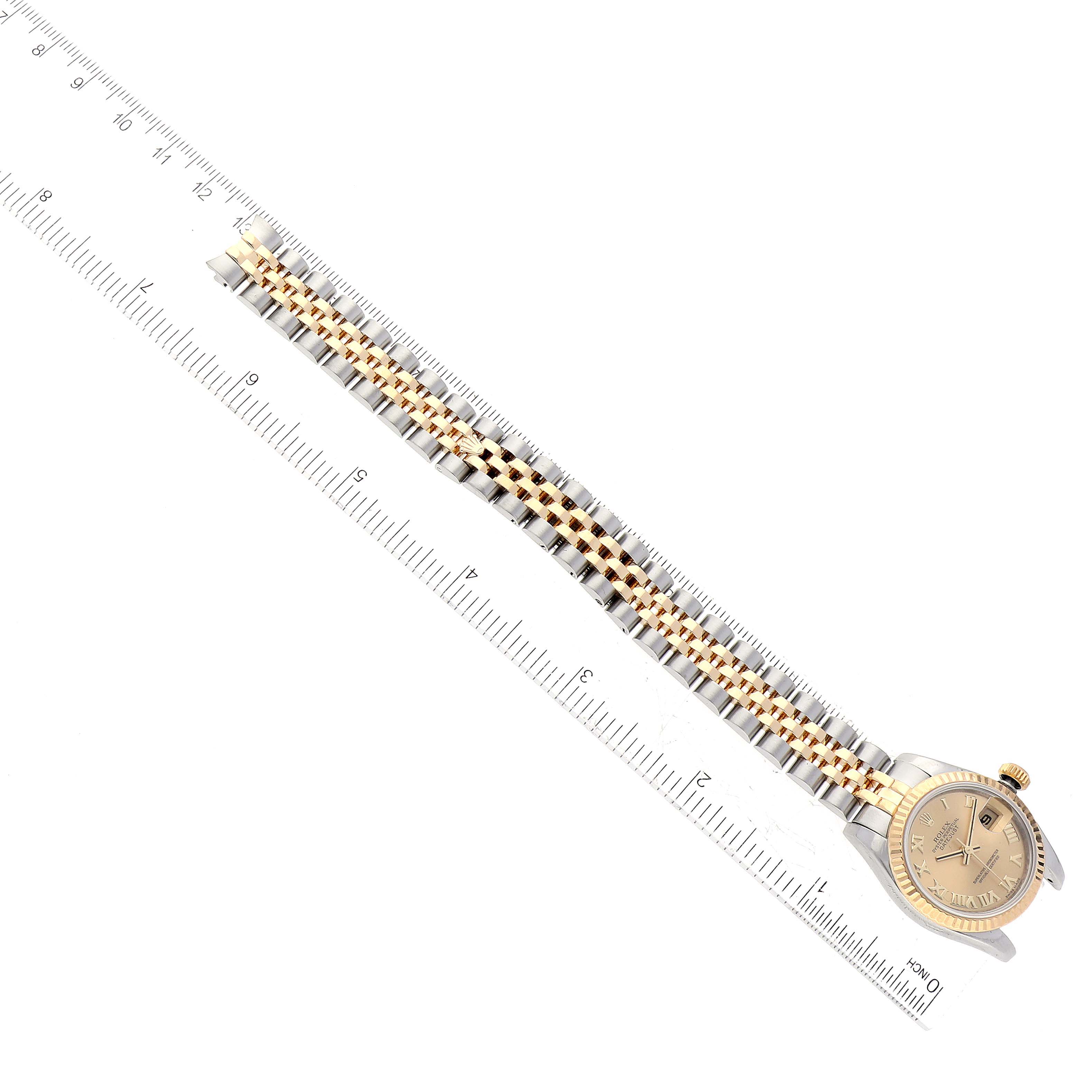 The Rolex Datejust 179173 Women's Steel and Gold (two tone) Champagne Dial 179173 Women's Steel and Gold (two tone) Champagne Dial watch is shown at a top-down angle, highlighting its face, crown, and two-tone bracelet.