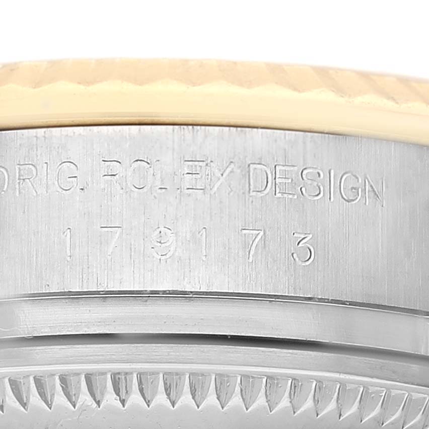This image shows a close-up of the case side and bezel of a Rolex Datejust 179173 Women's Steel and Gold (two tone) Champagne Dial 179173 Women's Steel and Gold (two tone) Champagne Dial, displaying the engraved markings.