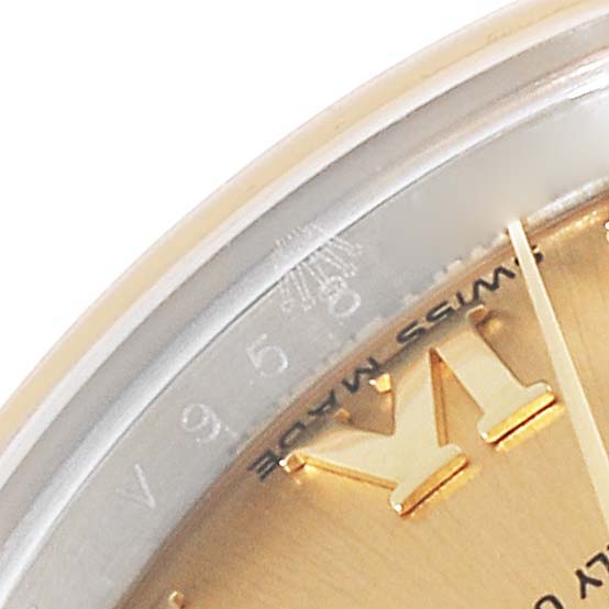 Close-up angle of the dial and bezel, featuring the Rolex Datejust 179173 Women's Steel and Gold (two tone) Champagne Dial 179173 Women's Steel and Gold (two tone) Champagne Dial model with Roman numerals and the "Swiss Made" label.