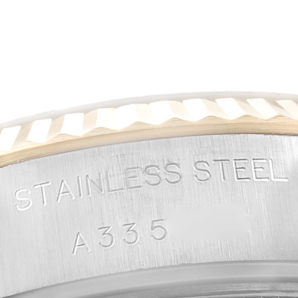 This image shows a close-up of the stainless steel case back and fluted bezel of a Rolex Datejust 79173 Women's Steel and Gold (two tone) Champagne Dial 79173 Women's Steel and Gold (two tone) Champagne Dial watch.