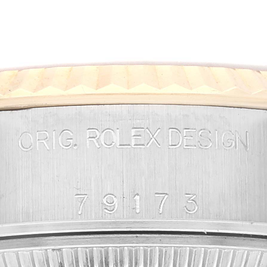 This image shows a close-up of the side of a Rolex Datejust 79173 Women's Steel and Gold (two tone) Grey Dial 79173 Women's Steel and Gold (two tone) Grey Dial watch, focusing on the engraved model number.