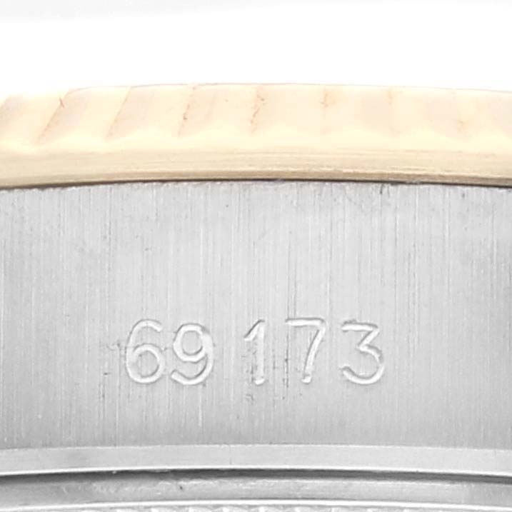 This is a close-up of the case back, focusing on an engraved serial number of the Rolex Datejust 69173 Women's Steel and Gold (two tone) Beige Dial 69173 Women's Steel and Gold (two tone) Beige Dial watch.