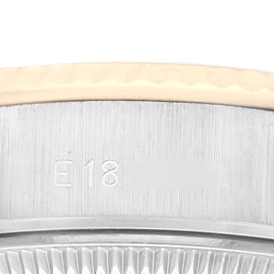 This close-up image shows the side engraving and part of the bezel of a Rolex Datejust 69173 Women's Steel and Gold (two tone) Beige Dial 69173 Women's Steel and Gold (two tone) Beige Dial watch.