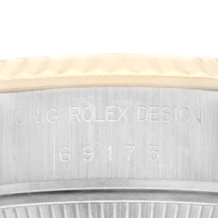 This is a close-up view of the side of a Rolex Datejust 69173 Women's Steel and Gold (two tone) Beige Dial 69173 Women's Steel and Gold (two tone) Beige Dial watch, showing the etching "ORIG. ROLEX DESIGN 69173."