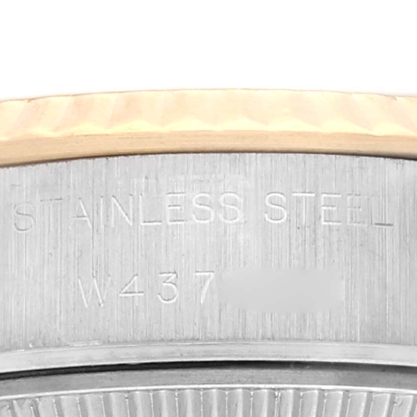 This image shows a close-up of the stainless steel and gold bezel of a Rolex Datejust 69173 Women's Steel and Gold (two tone) Beige Dial 69173 Women's Steel and Gold (two tone) Beige Dial watch, focusing on the engraved text.