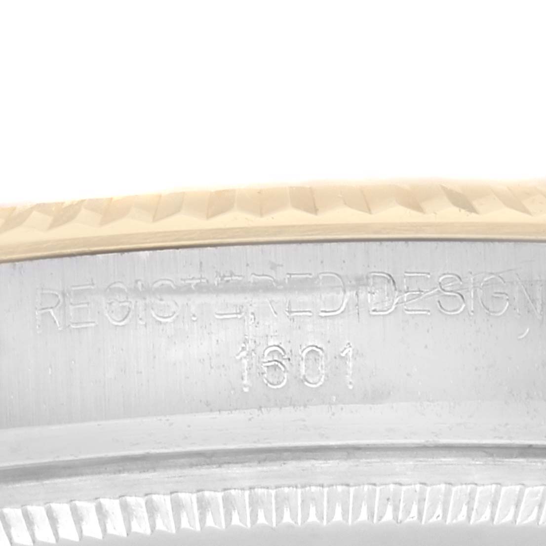 This is a close-up of the side of the Rolex Vintage Collection 1601 Men's Steel and Gold (two tone) Champagne Dial 1601 Men's Steel and Gold (two tone) Champagne Dial watch, showing the model number 1601 and a portion of the bezel.