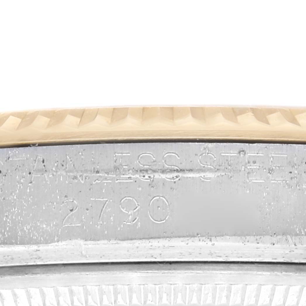 This image shows a close-up of the side of the case and bezel of a Rolex Vintage Collection 1601 Men's Steel and Gold (two tone) Champagne Dial 1601 Men's Steel and Gold (two tone) Champagne Dial model, featuring the inscription.