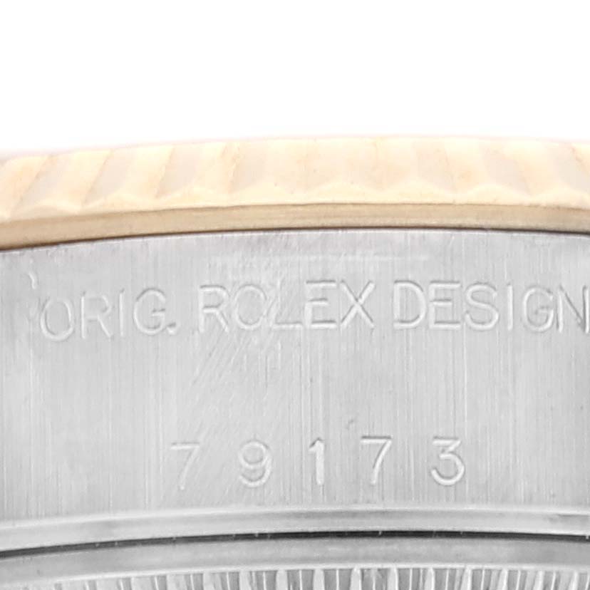 The image shows a close-up of the side of a Rolex Datejust 79173 Women's Steel and Gold (two tone) White Dial 79173 Women's Steel and Gold (two tone) White Dial watch, highlighting the stamped text and the model number 79173.